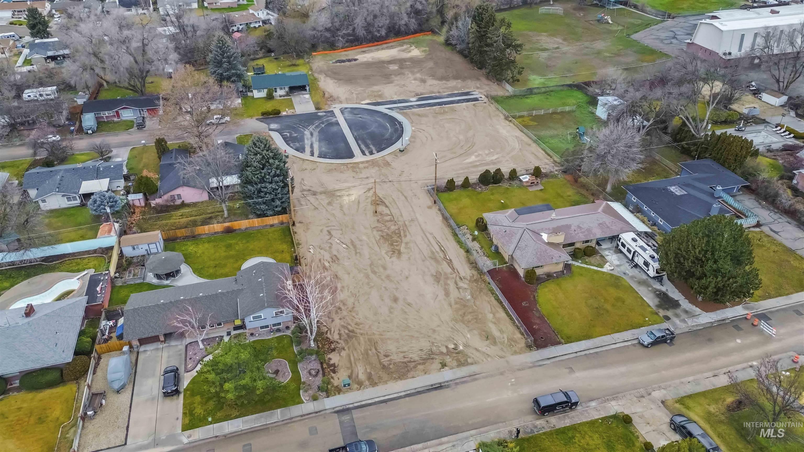 Aerial view of property and surrounding area with nearby suburban area