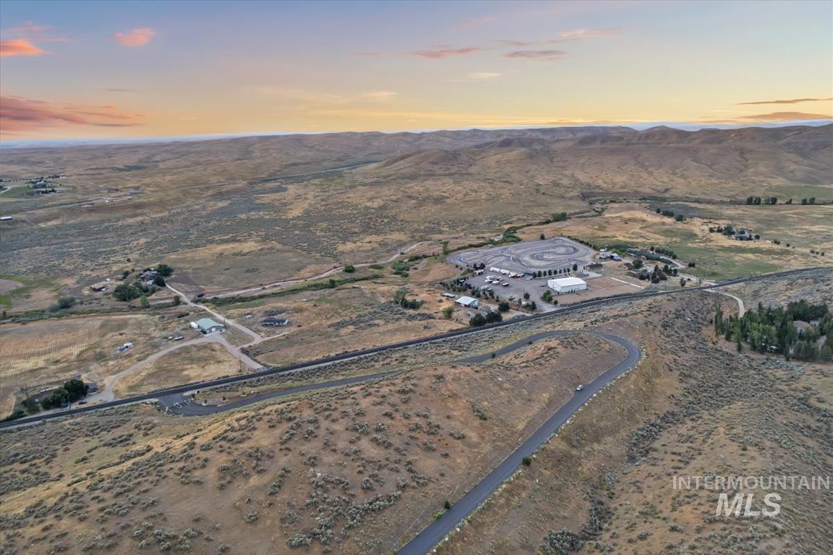 Aerial view of property's location featuring a mountainous background and rural landscape
