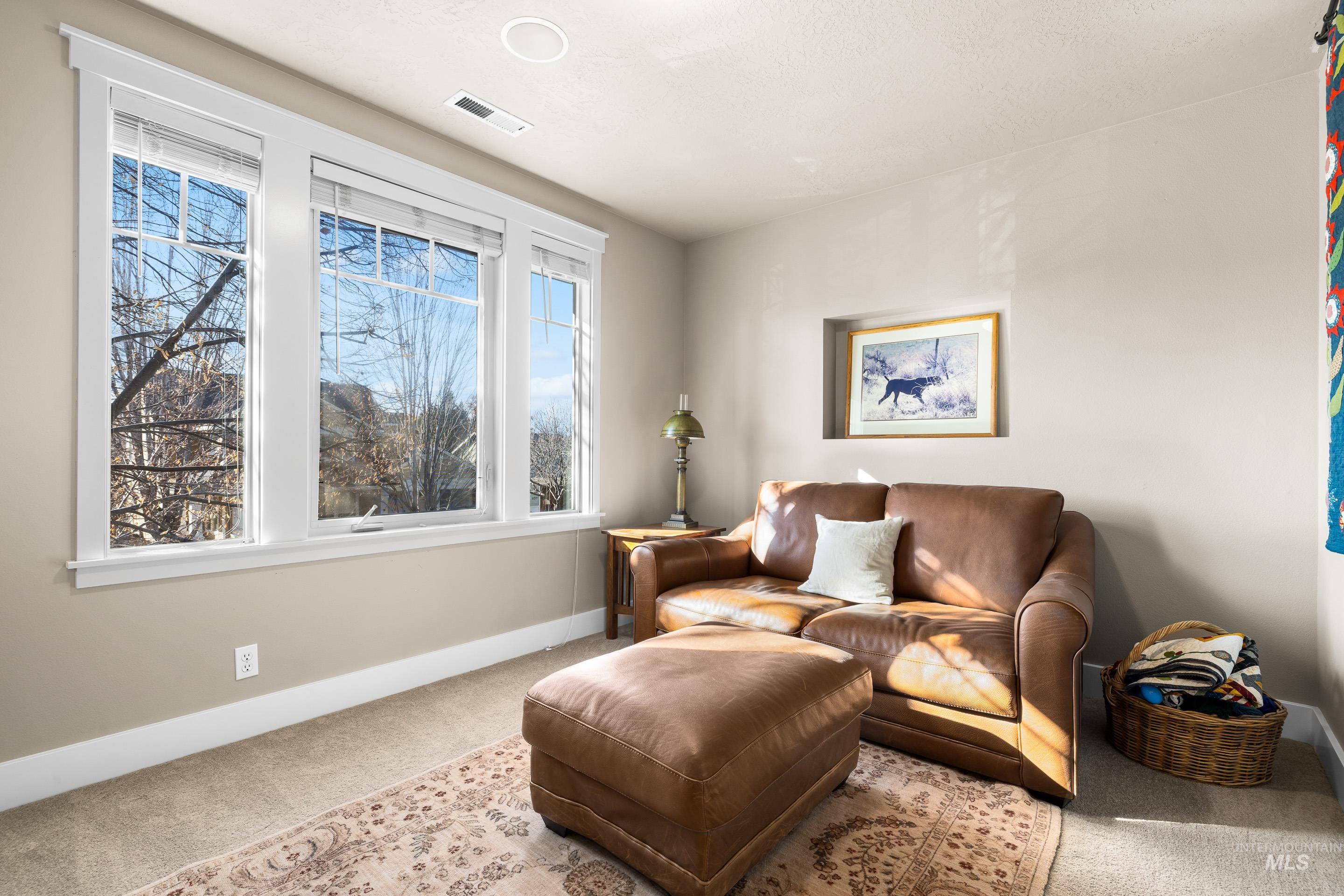 Sitting room featuring carpet floors and baseboards