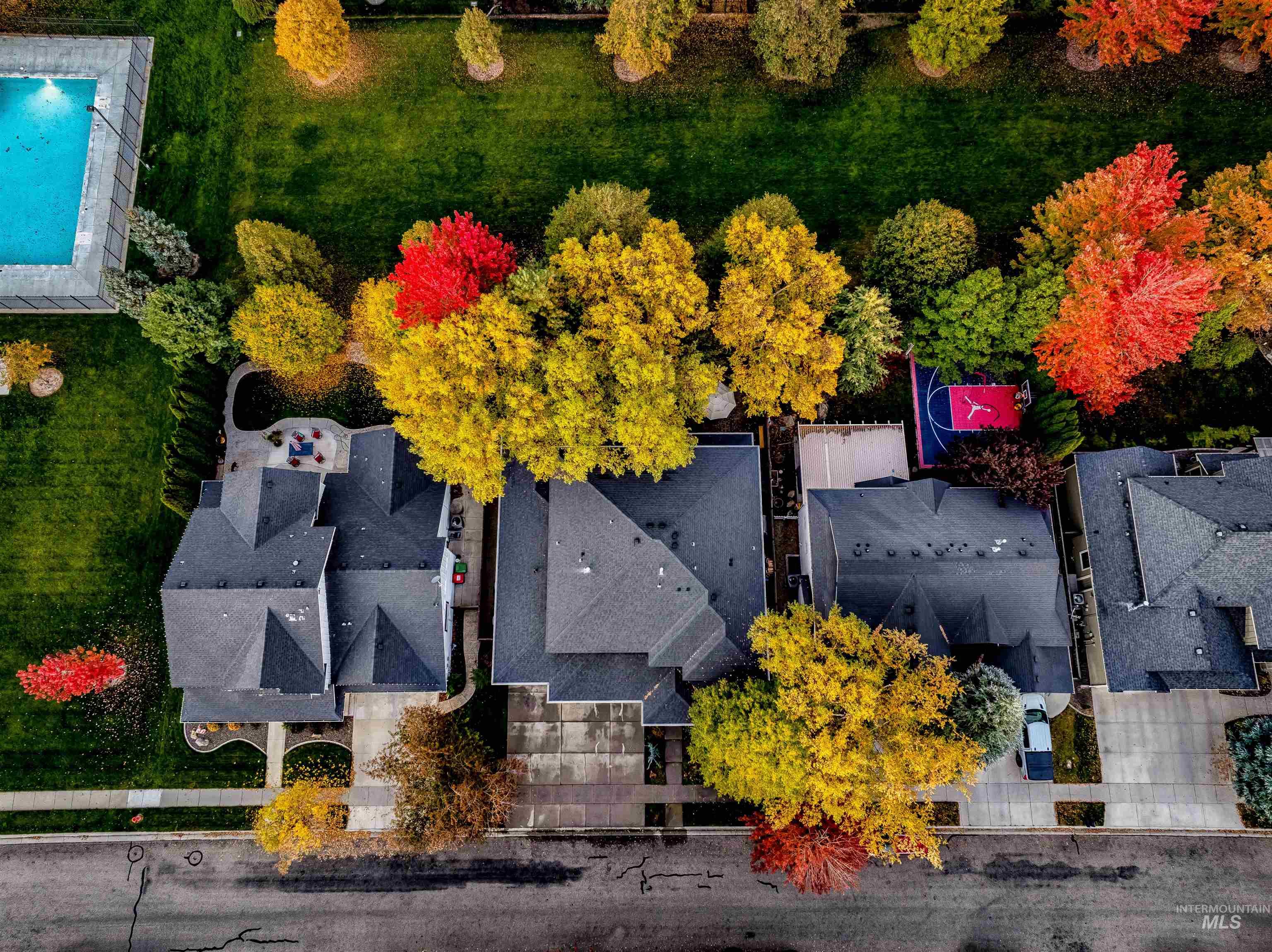 Aerial view of residential area featuring a pool