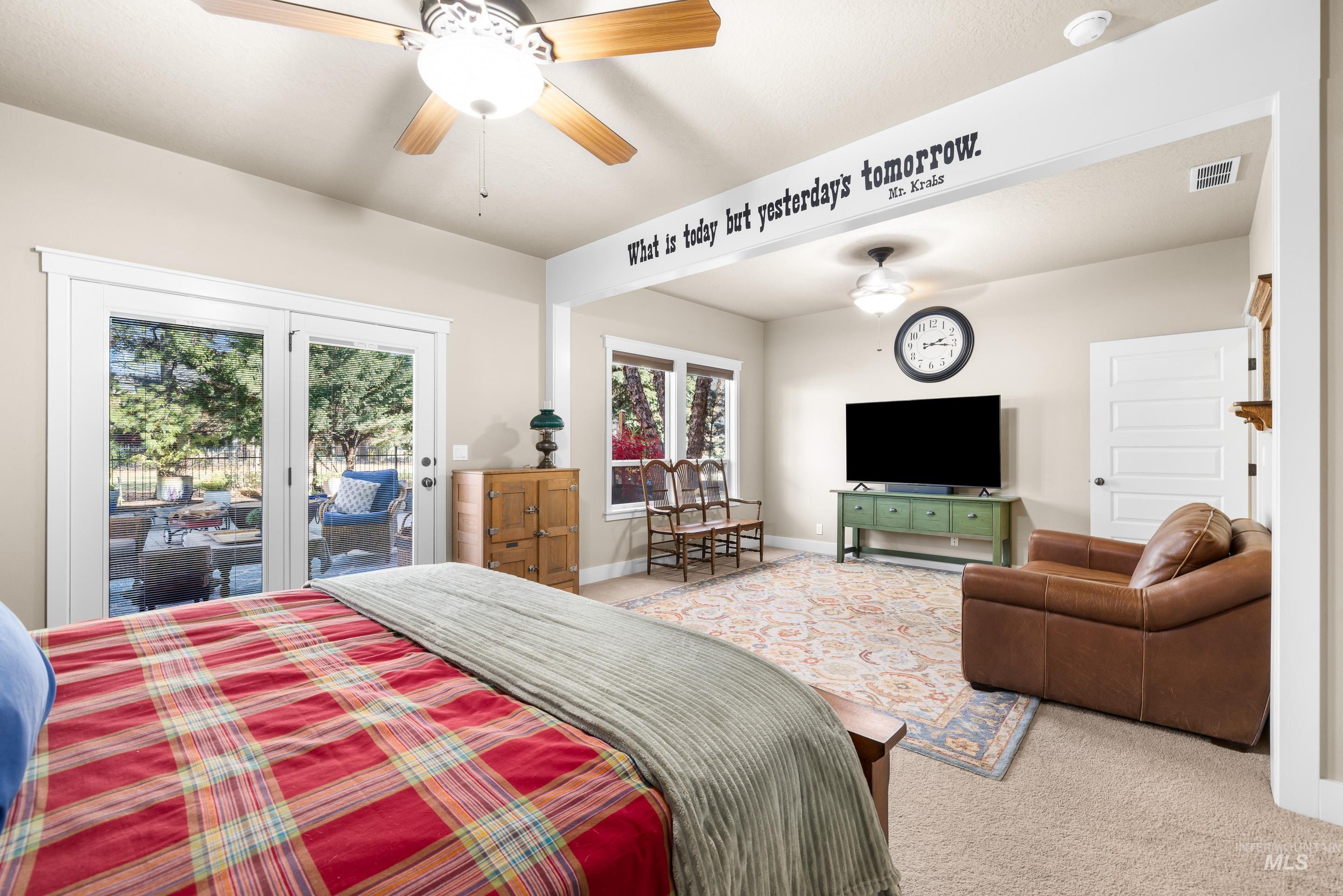 Carpeted bedroom with access to exterior and ceiling fan