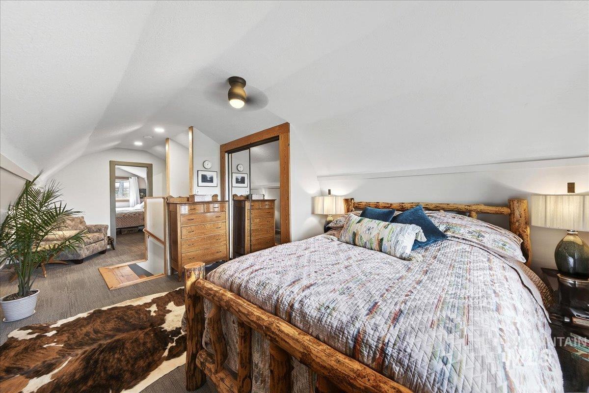 Bedroom featuring lofted ceiling and a closet