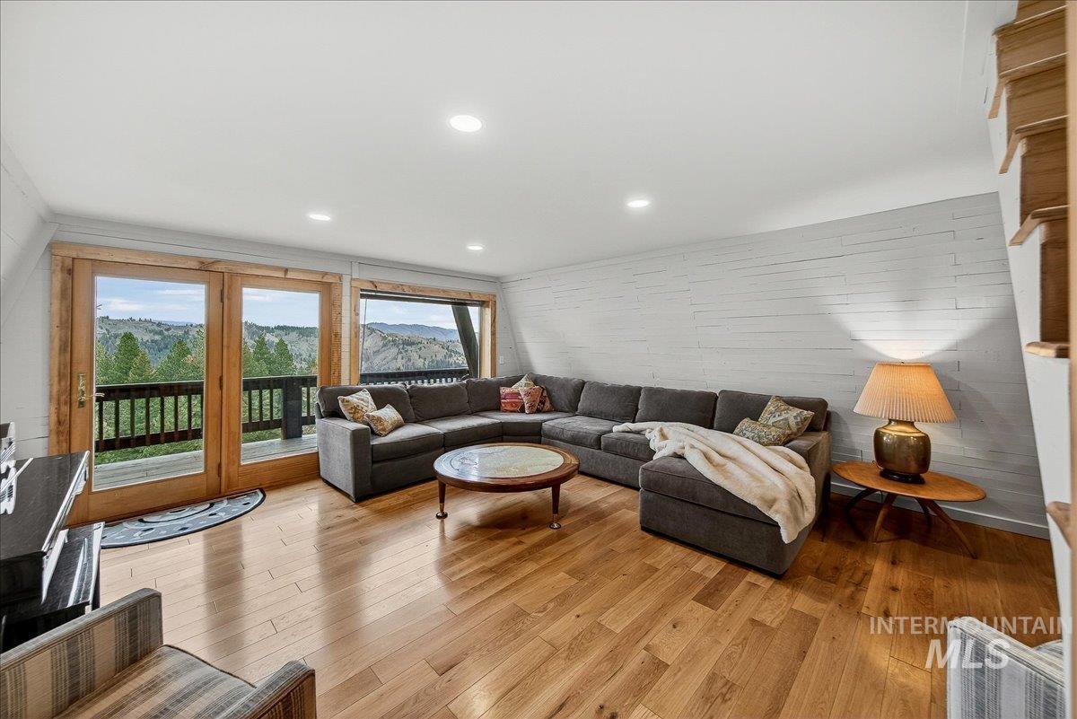 Living room featuring light wood-style flooring and recessed lighting