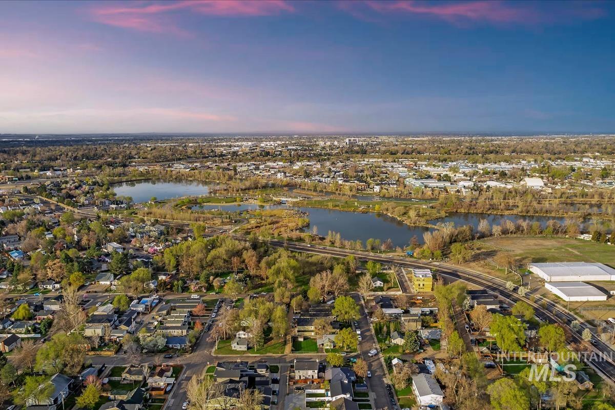 View of property location with a nearby body of water and nearby suburban area