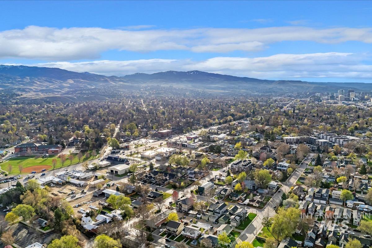 Aerial view of property and surrounding area with mountains