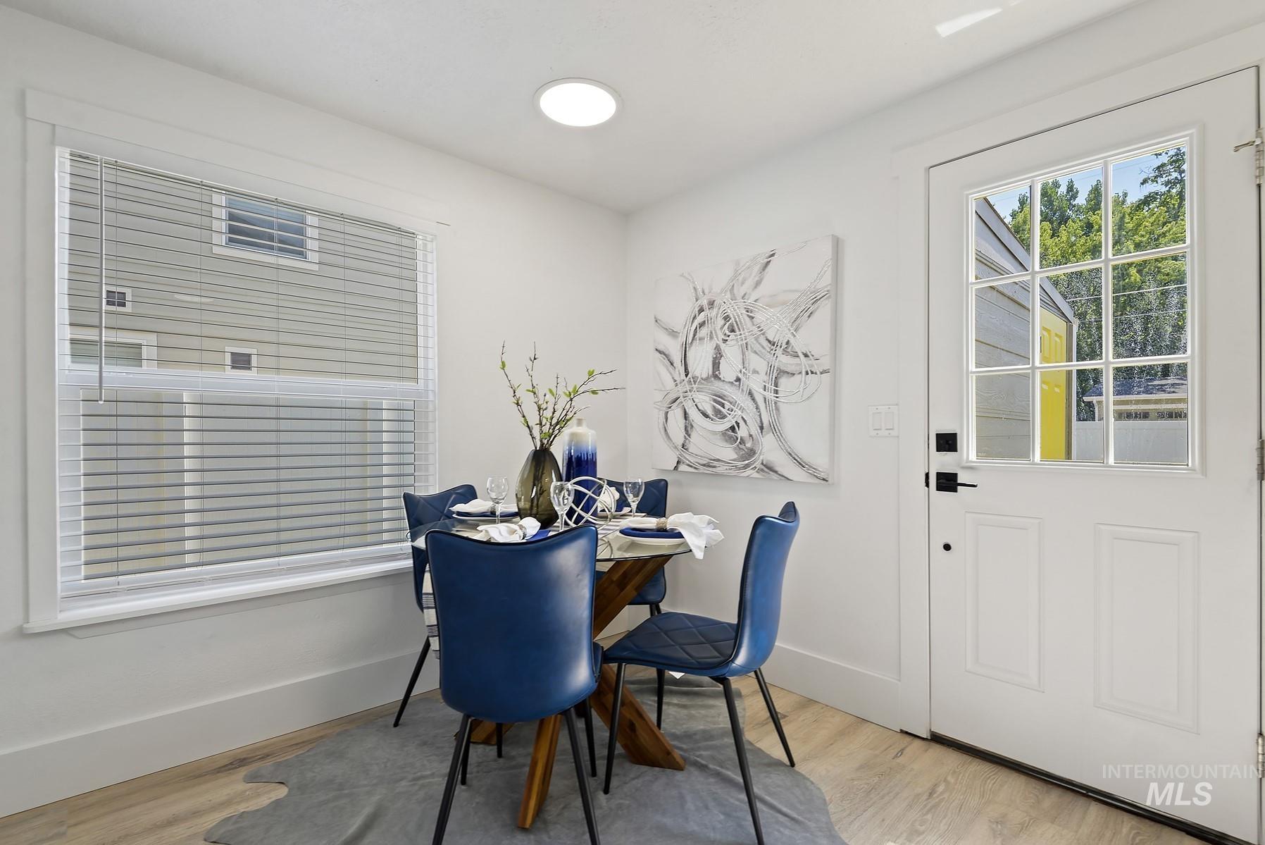 Dining space featuring light wood-style flooring and baseboards