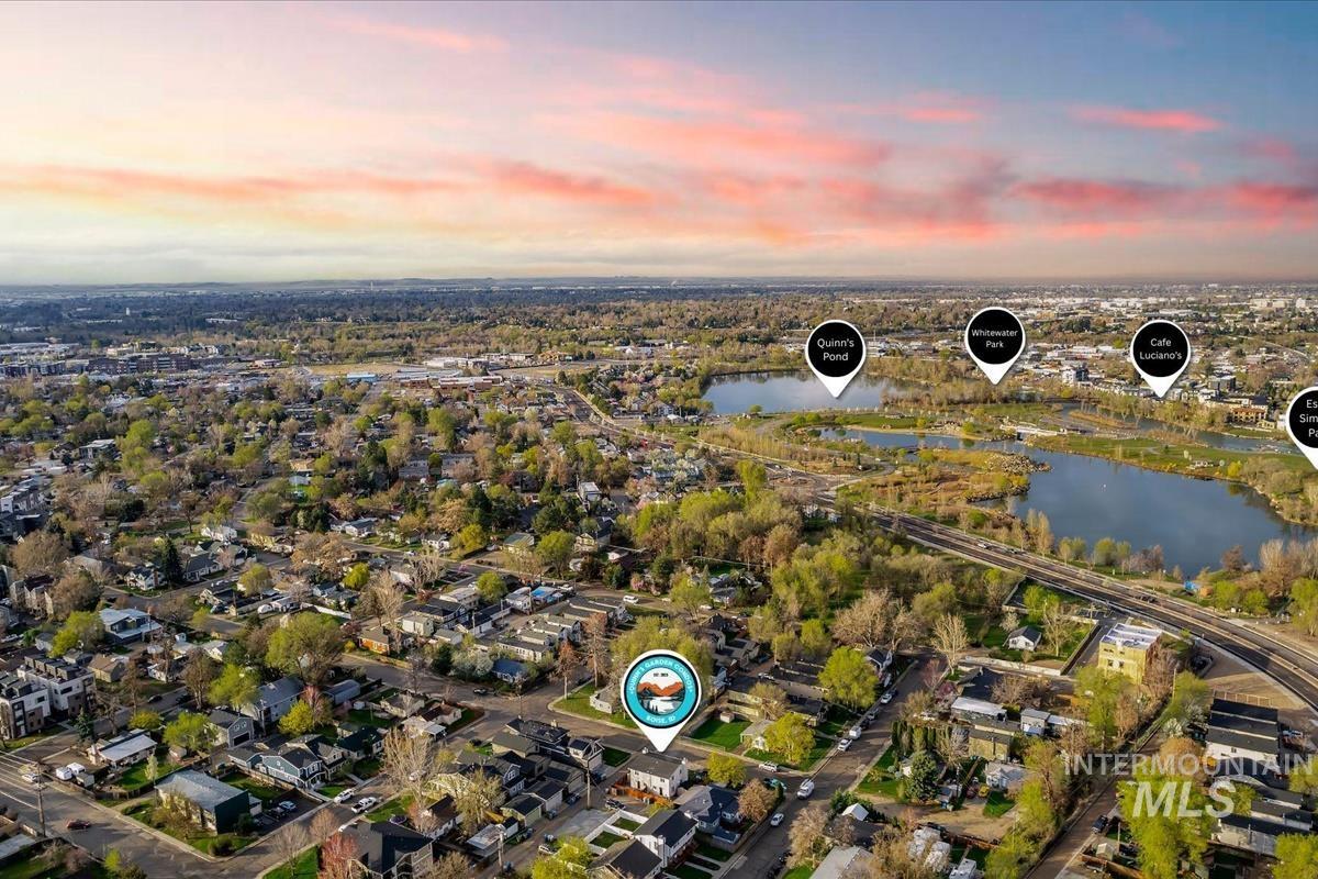 Aerial overview of property's location featuring a large body of water and nearby suburban area