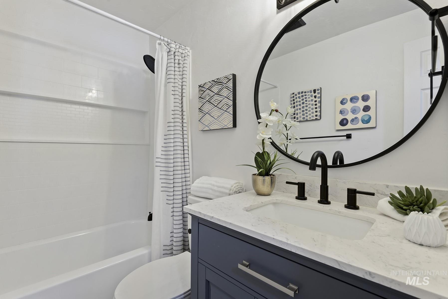 Full bath featuring vanity and shower / bath combination with curtain