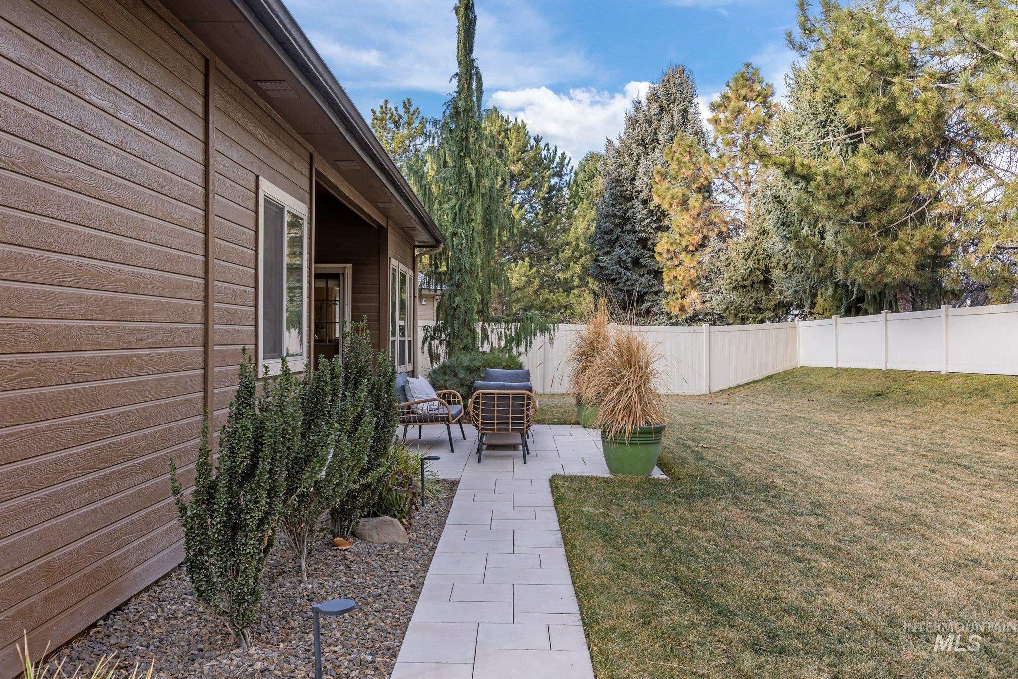 Fenced backyard featuring a patio