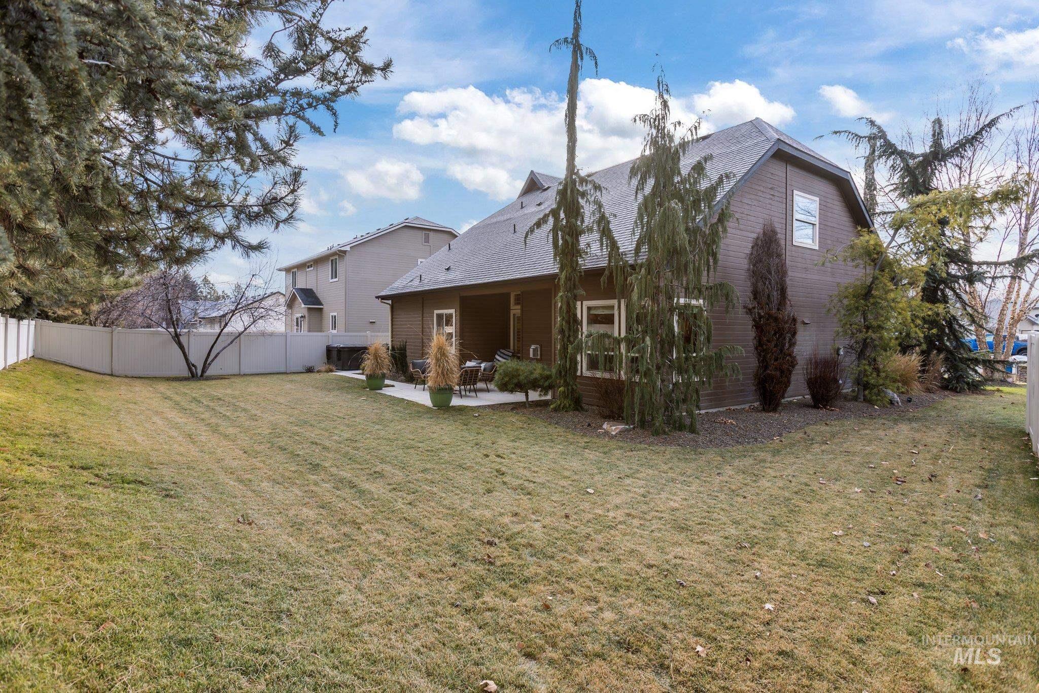 Back of property featuring a patio and a shingled roof
