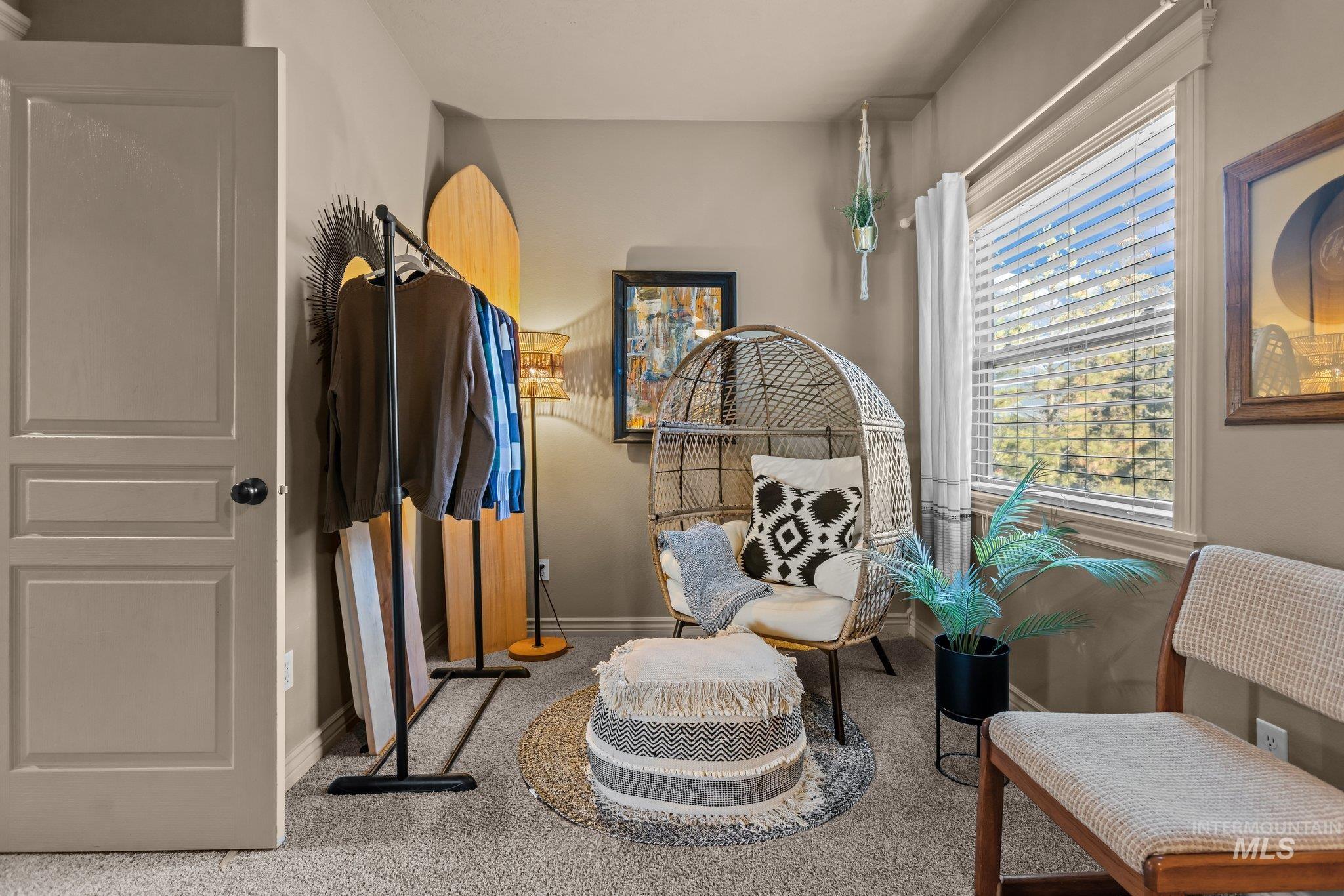 Living area with carpet flooring and baseboards