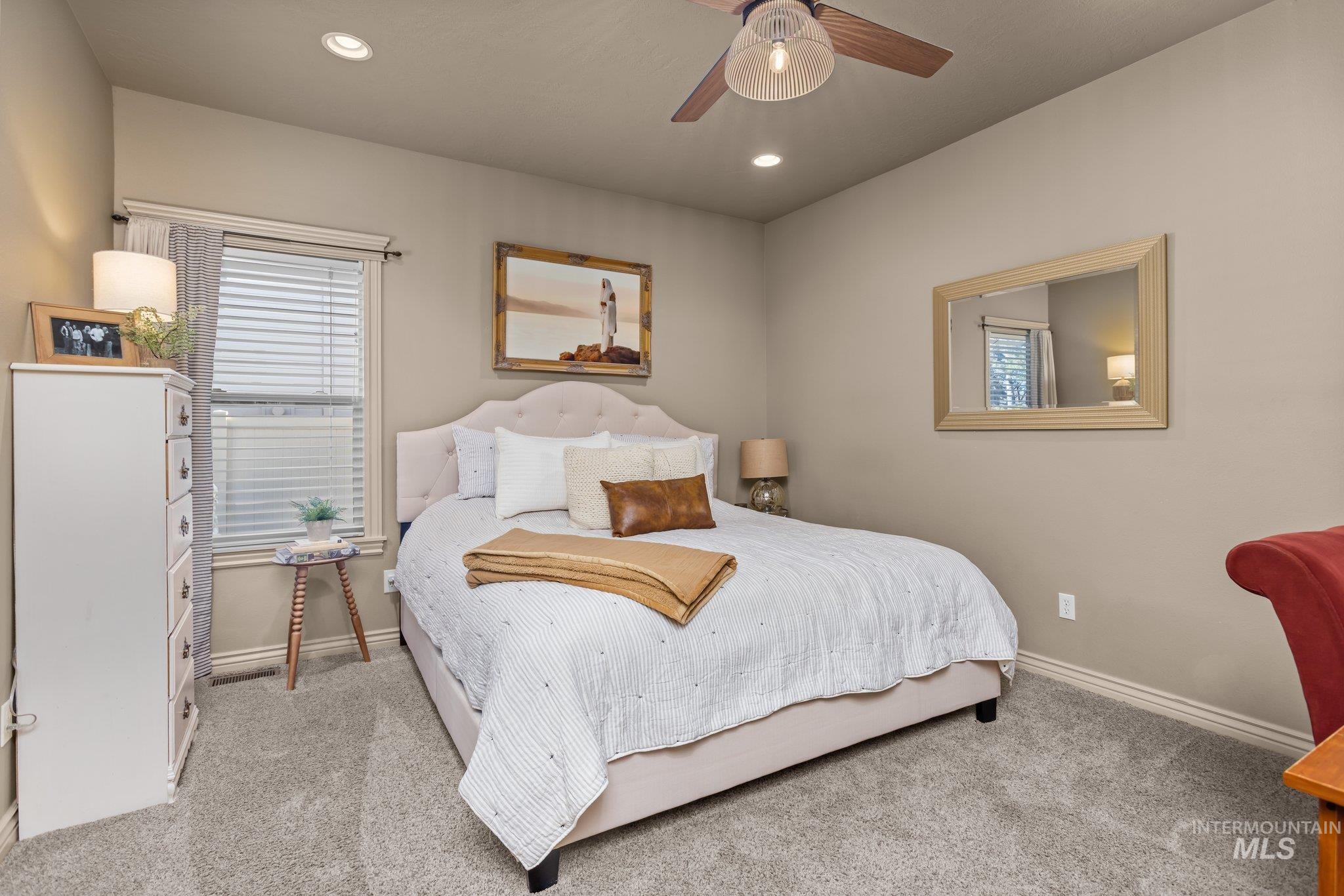 Bedroom featuring  colored carpet, a ceiling fan, and recessed lighting