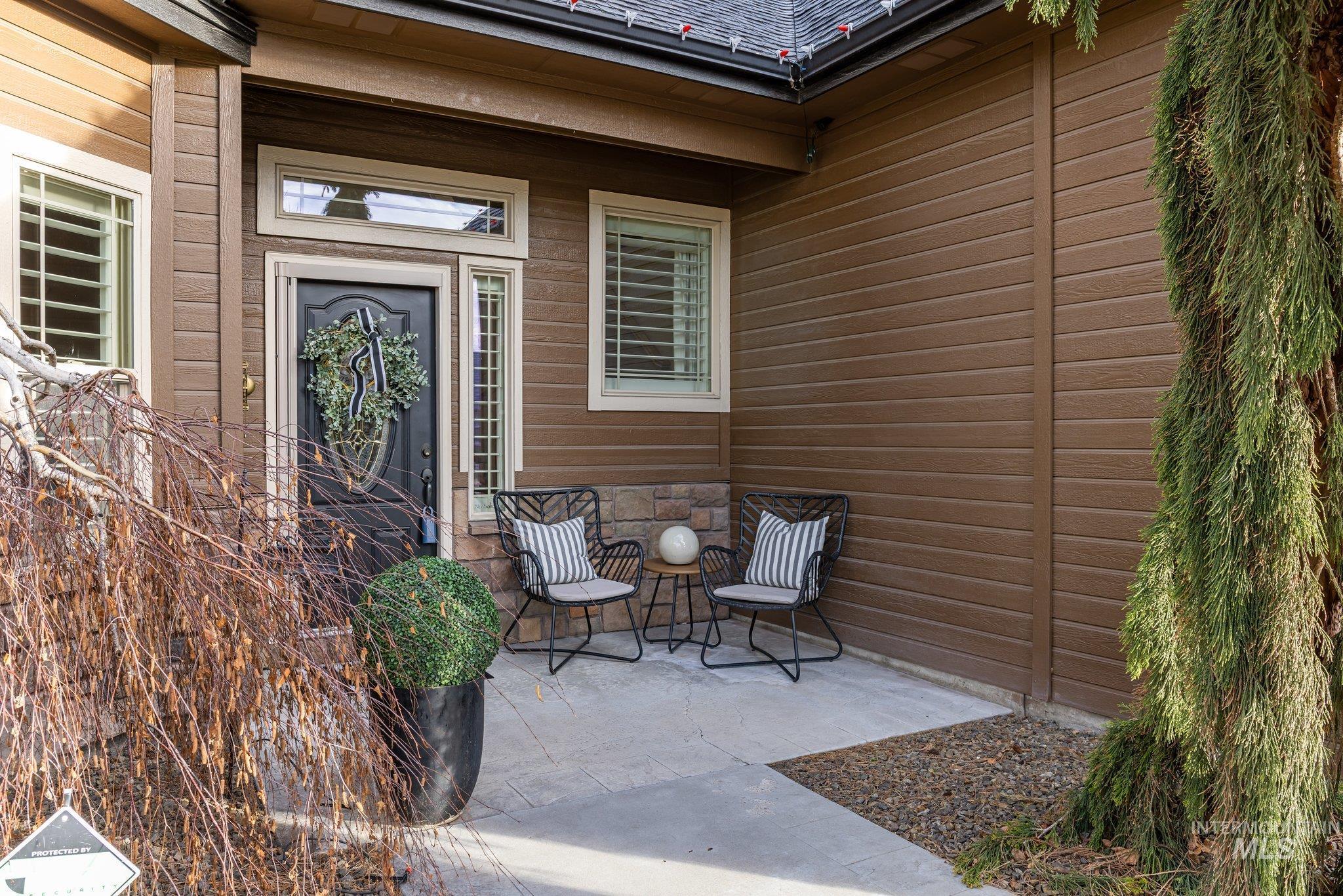 Doorway to property featuring a patio