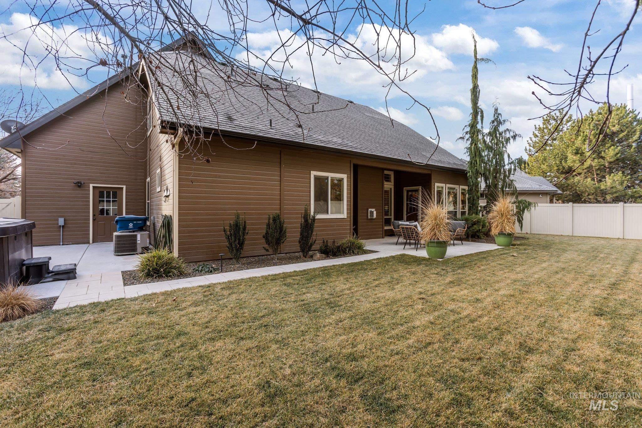 Back of property featuring a patio and roof with shingles