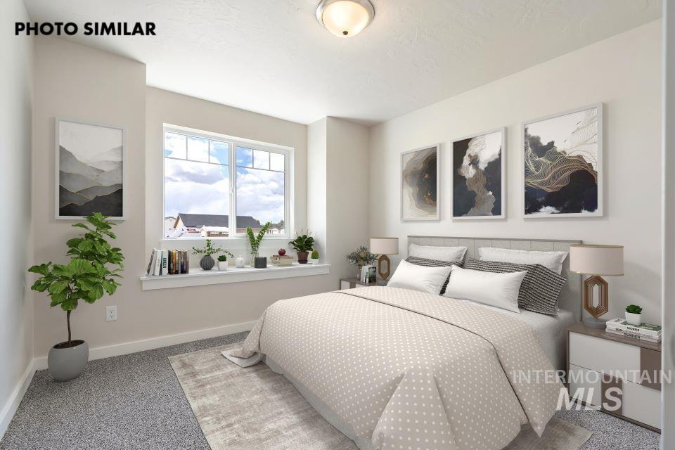 Carpeted bedroom featuring baseboards