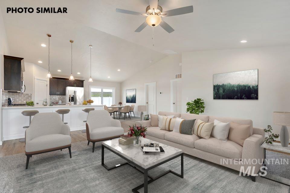 Living room featuring light wood finished floors, recessed lighting, high vaulted ceiling, and ceiling fan