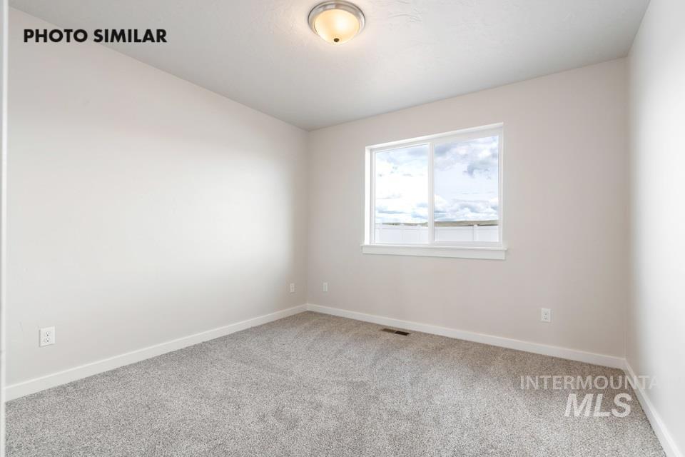 Unfurnished room with carpet floors and baseboards