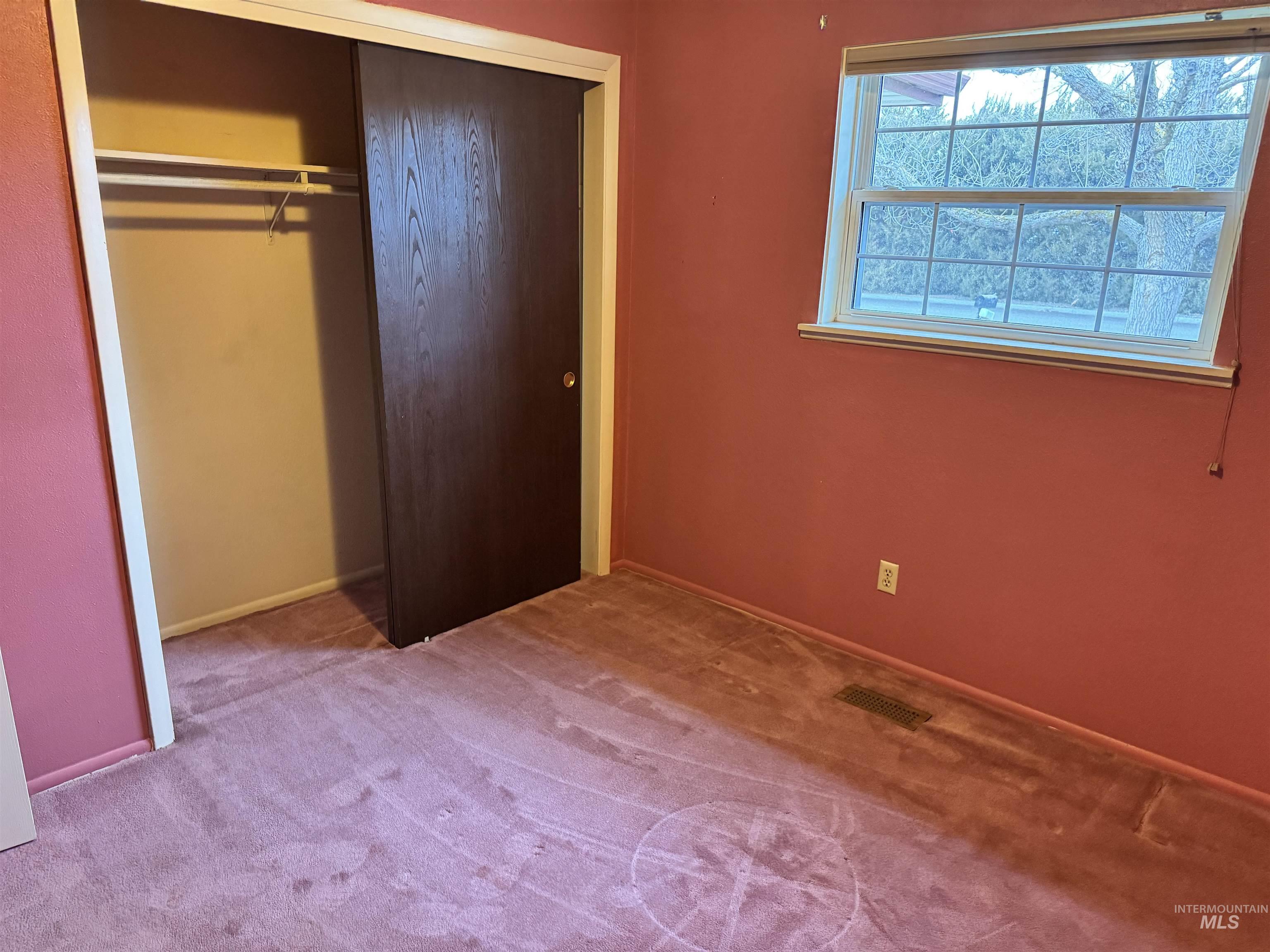 Unfurnished bedroom featuring carpet floors and a closet