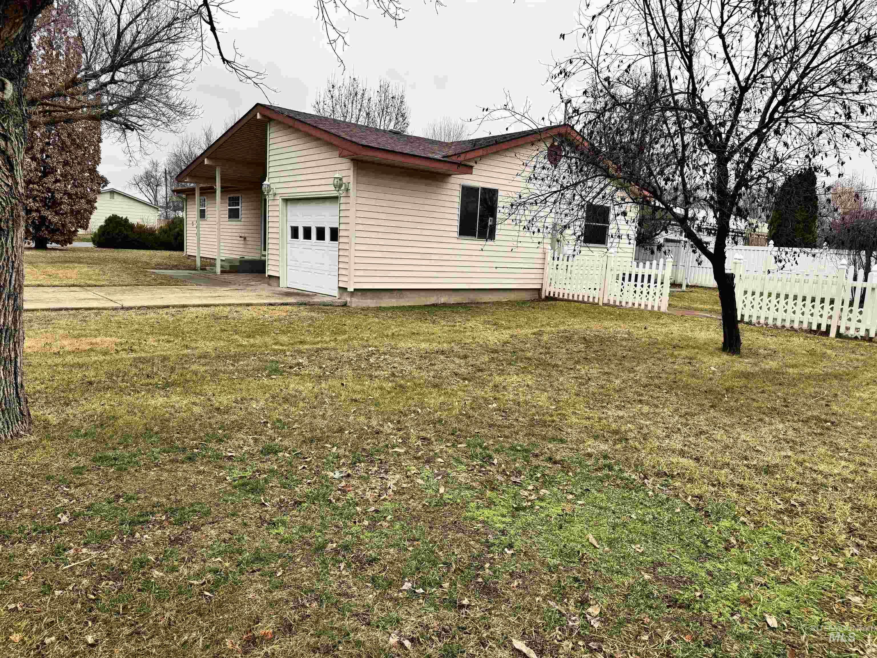 View of side of property with a garage and driveway