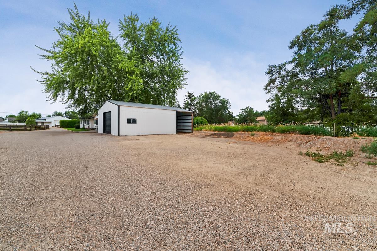 View of yard with an outbuilding and a pole building