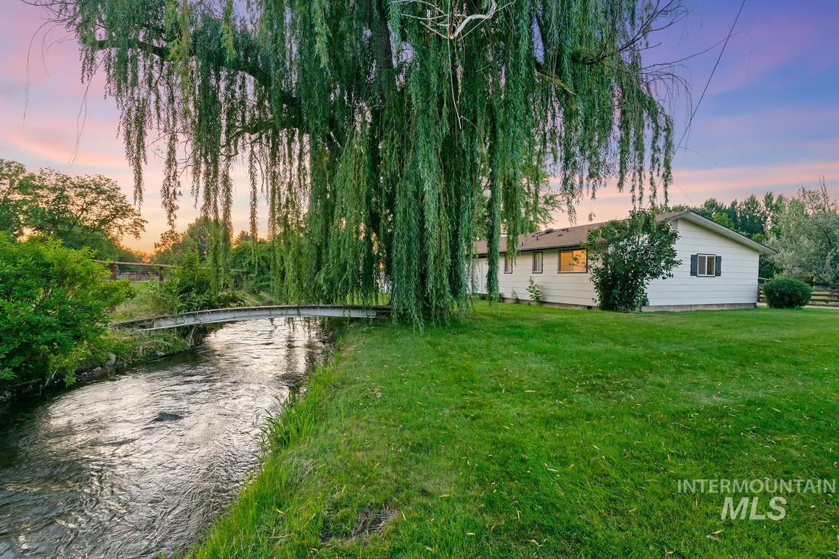 View of green lawn with a water view
