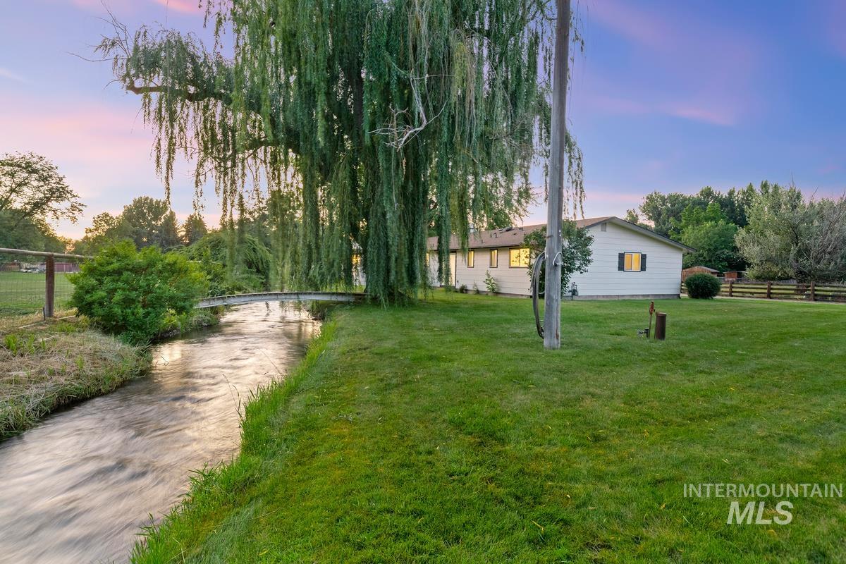 Yard at dusk featuring driveway