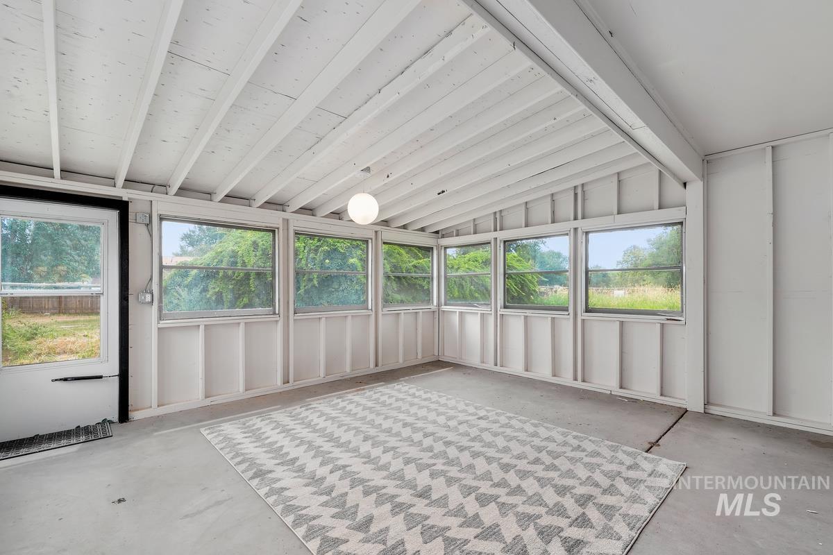 Unfurnished sunroom with healthy amount of natural light