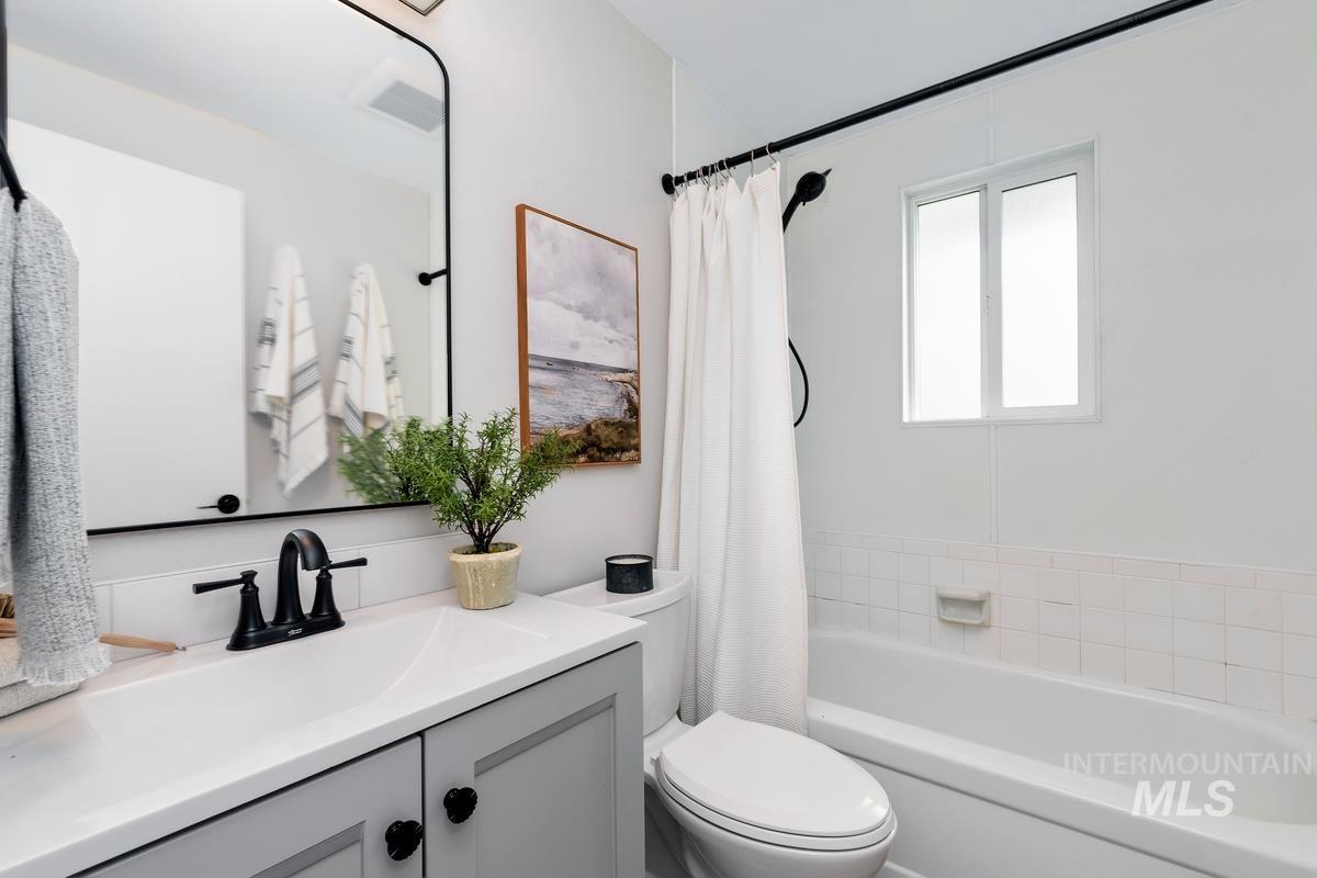 Full bath with vanity and shower / bathtub combination with curtain