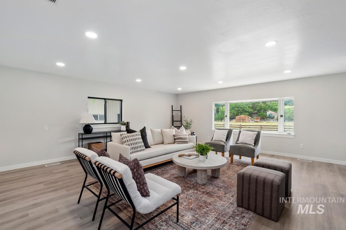 Living area featuring light wood-style flooring and recessed lighting
