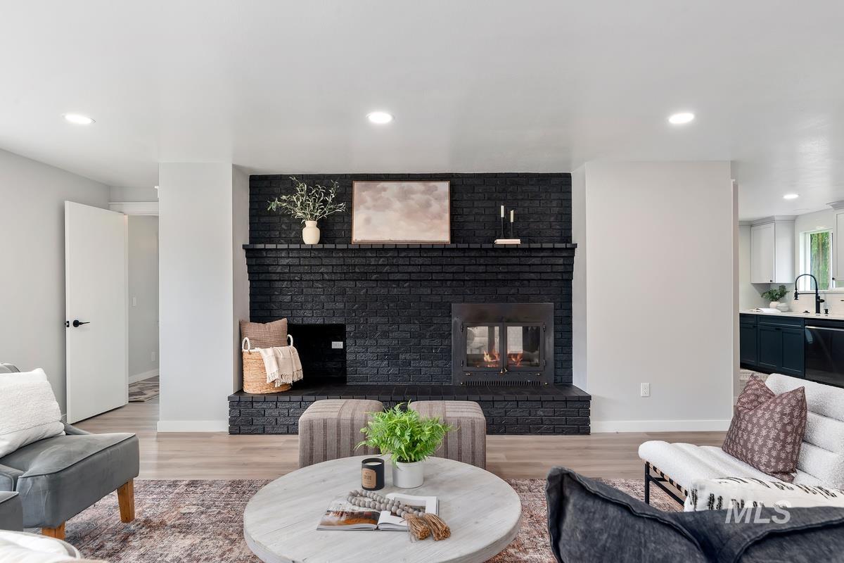 Living area featuring a fireplace, light wood finished floors, and recessed lighting