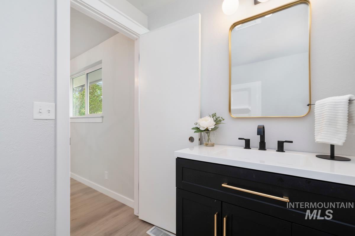 Bathroom with vanity and wood finished floors