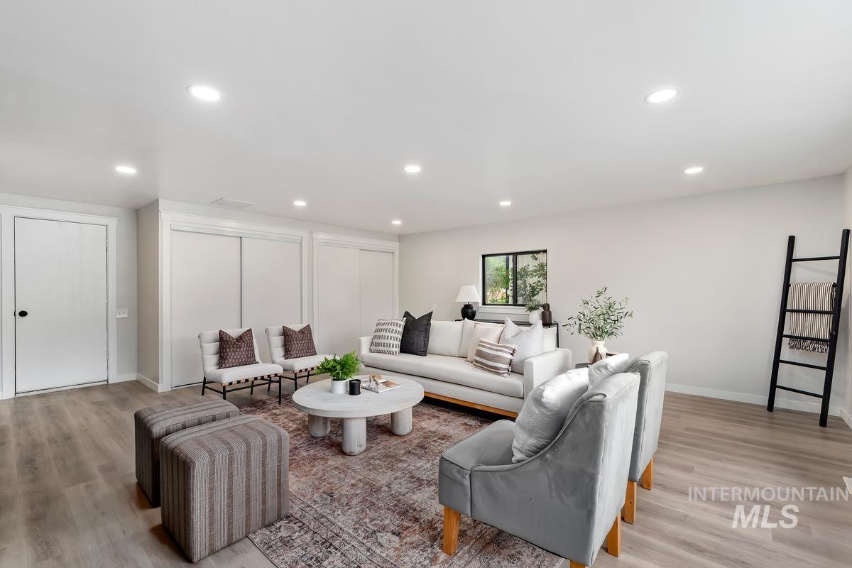 Living room featuring light wood-style flooring and recessed lighting