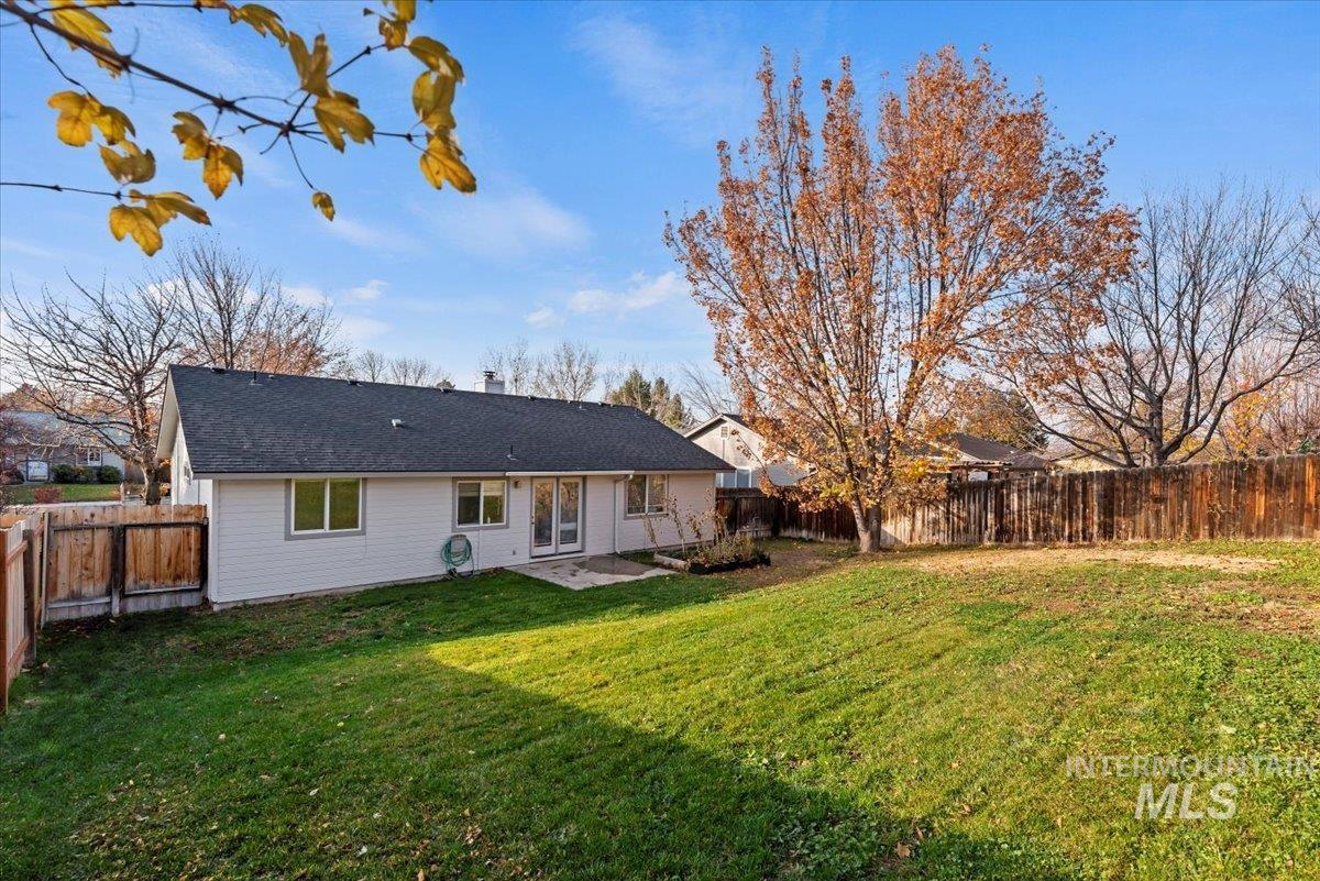 Rear view of property with a fenced backyard, a patio area, and a chimney