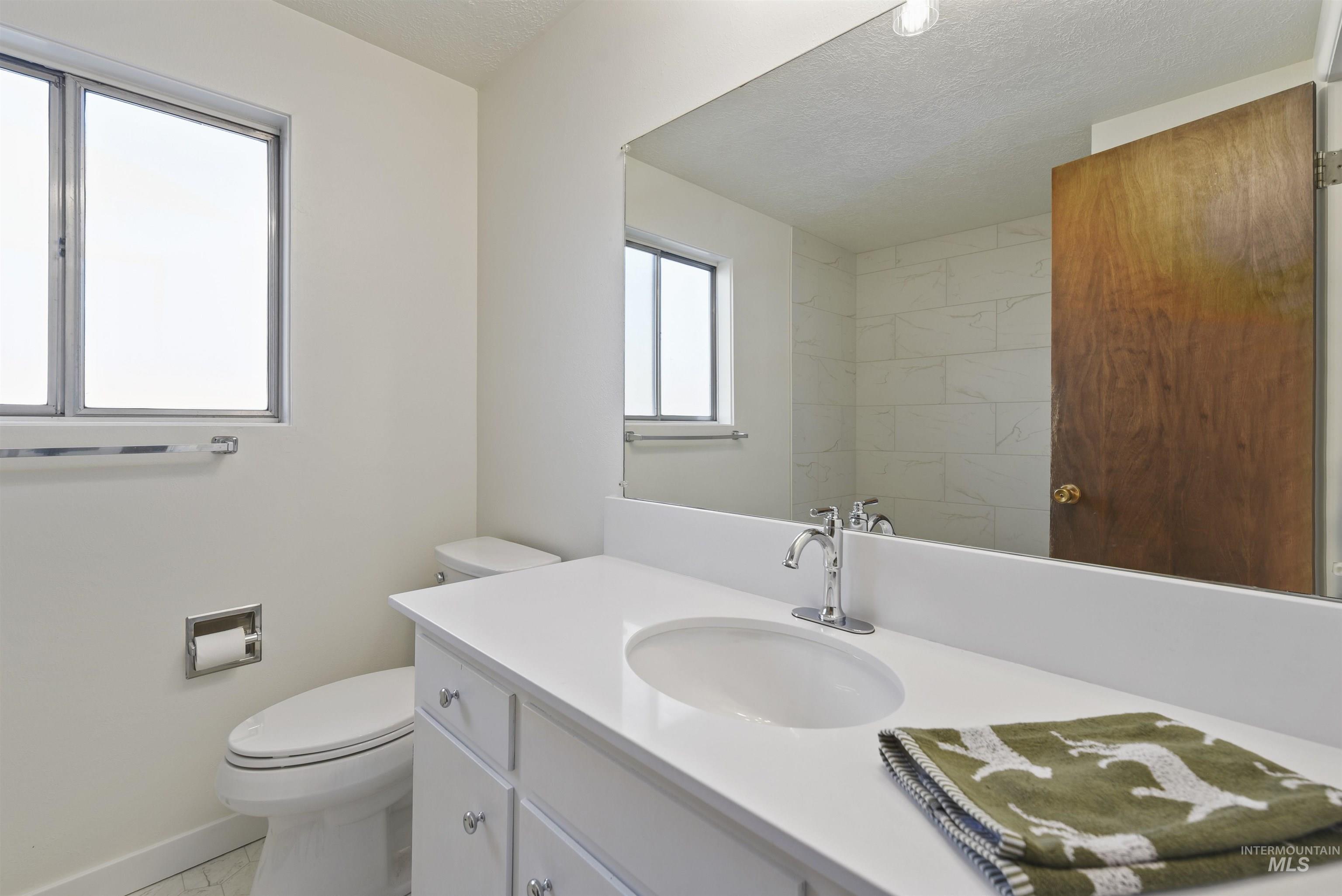Bathroom featuring vanity and a textured ceiling