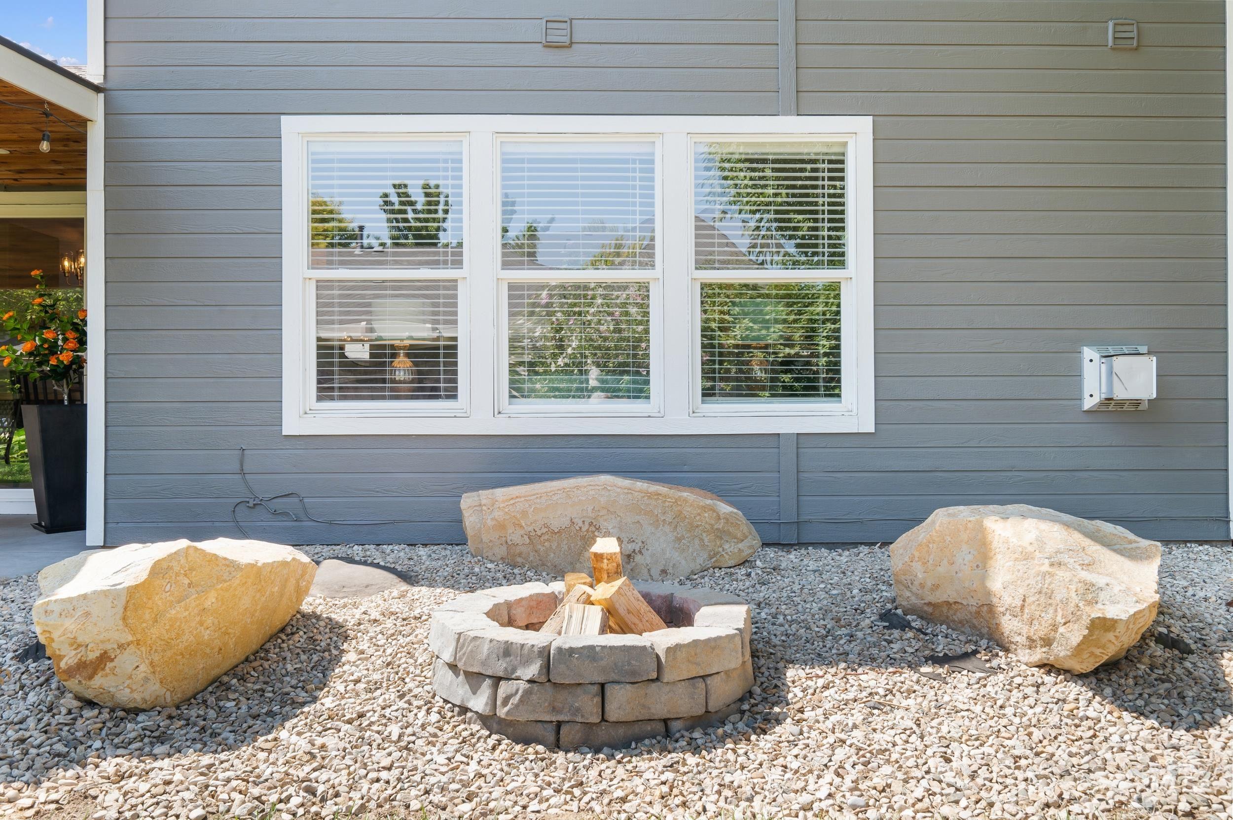 View of property exterior with a fire pit