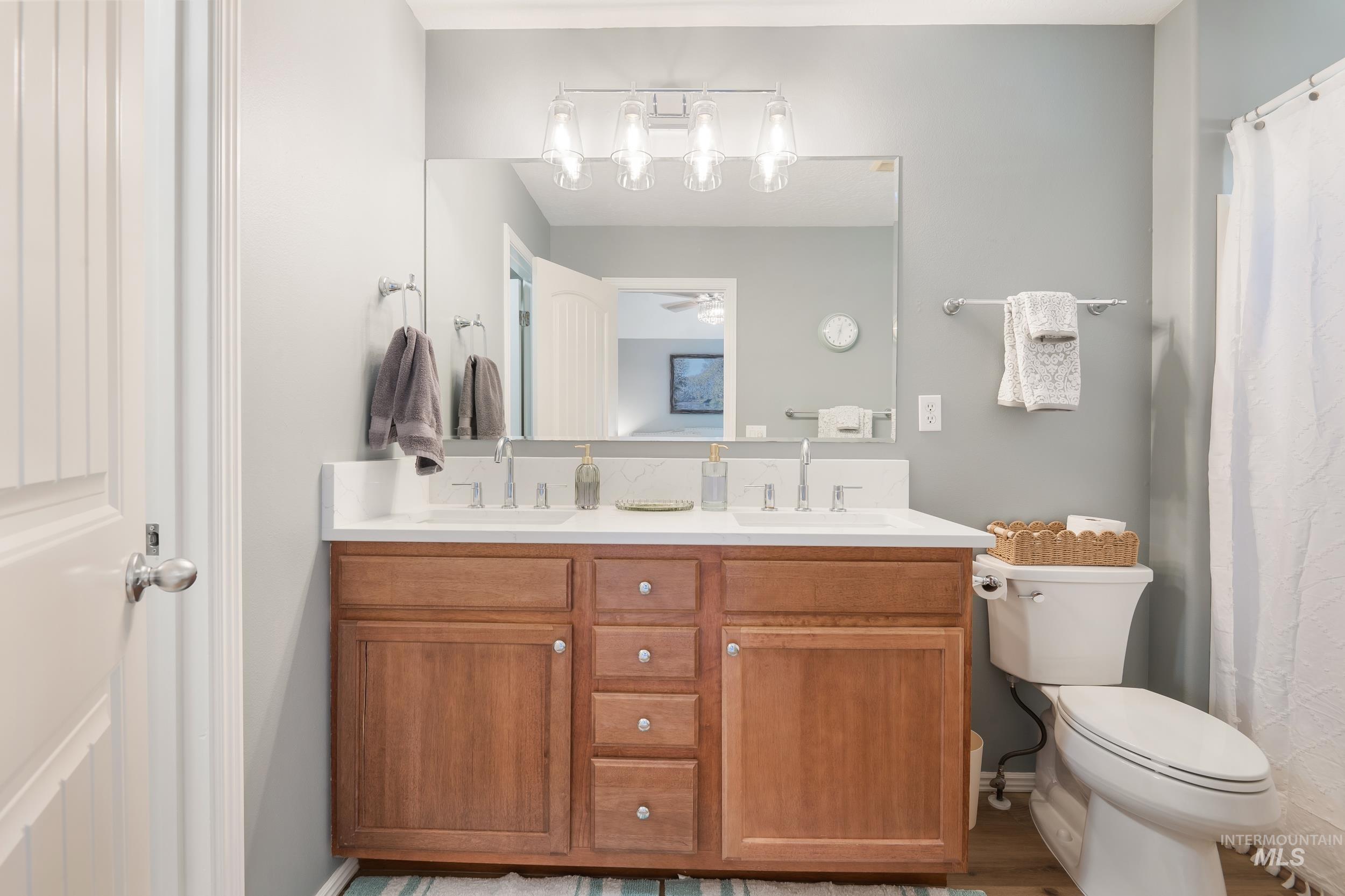 Bathroom featuring double vanity and a ceiling fan