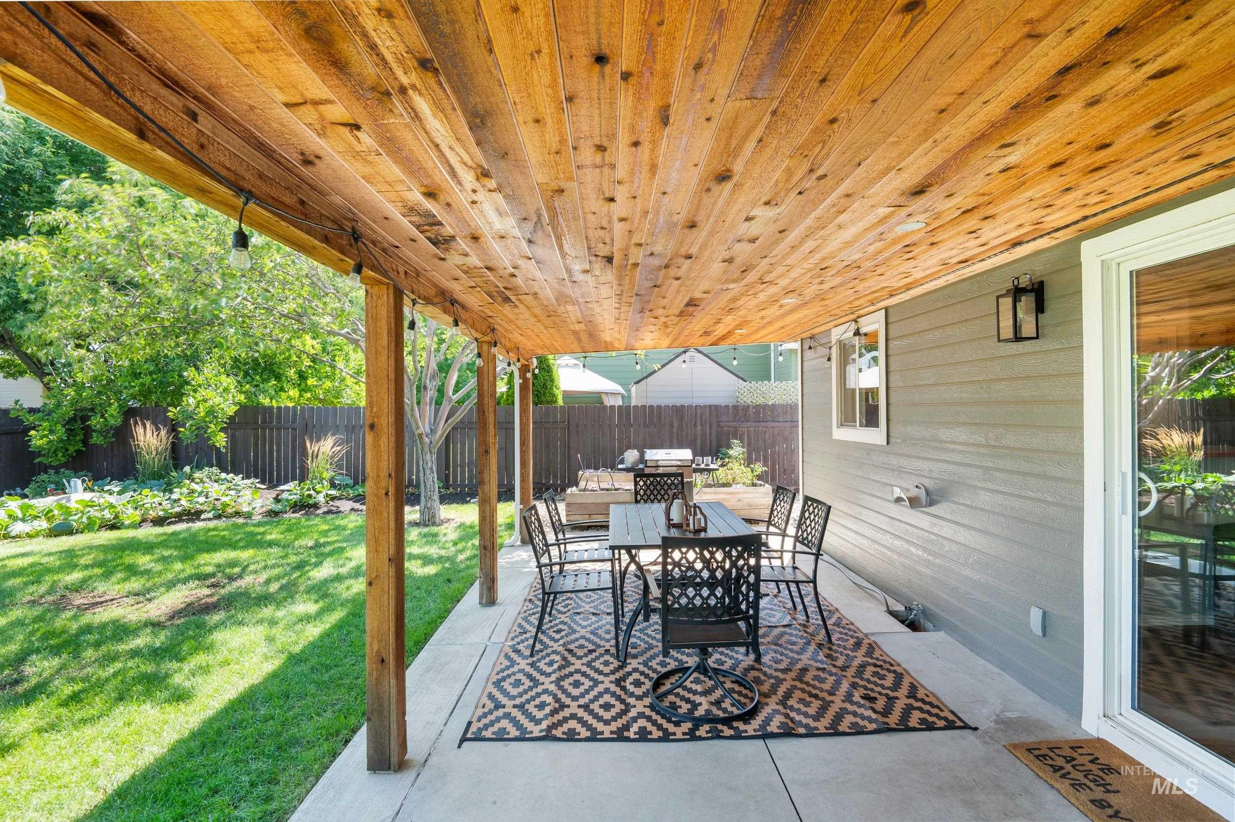 Fenced backyard featuring a patio area and outdoor dining area