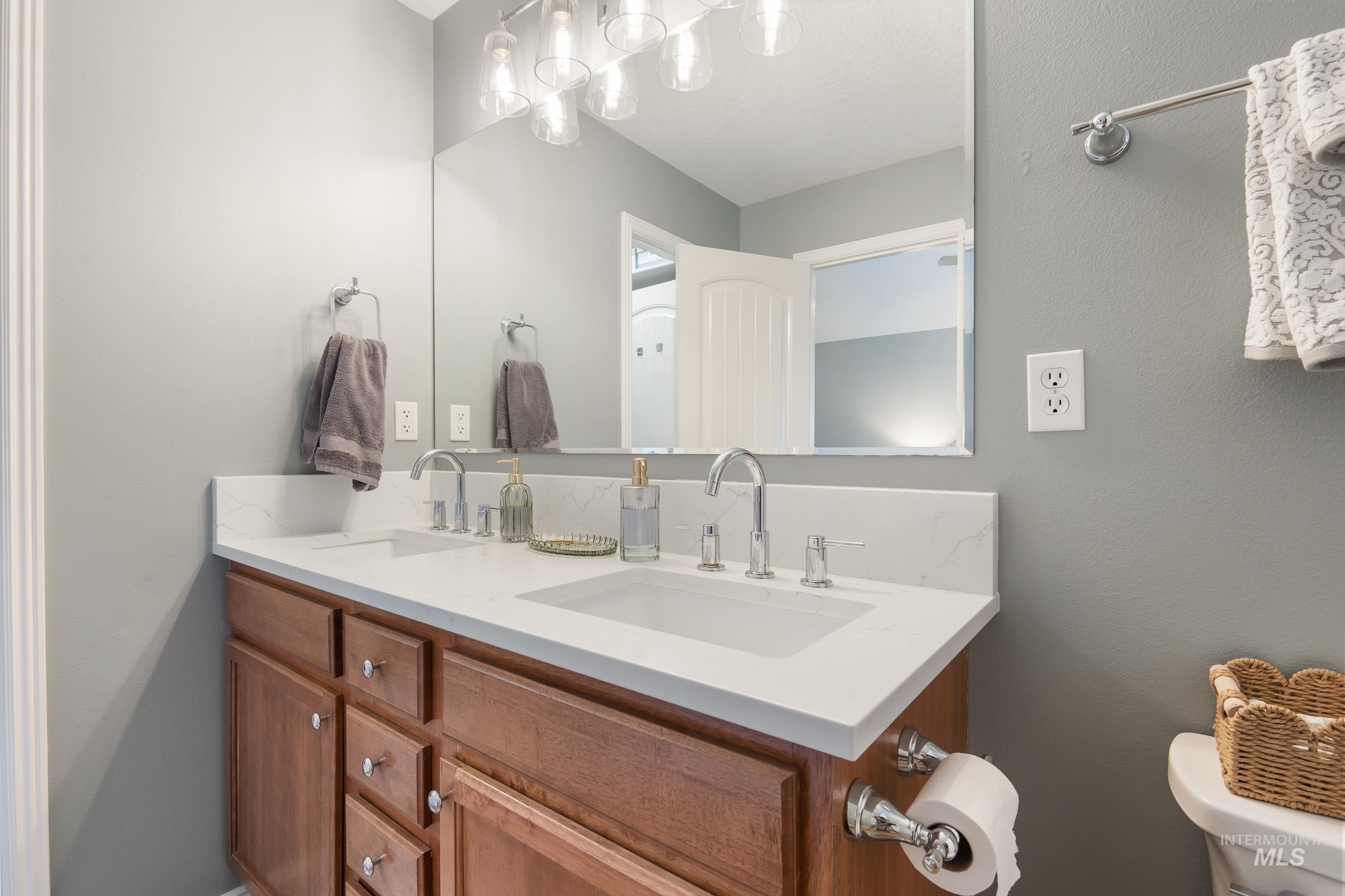 Bathroom featuring toilet and double vanity