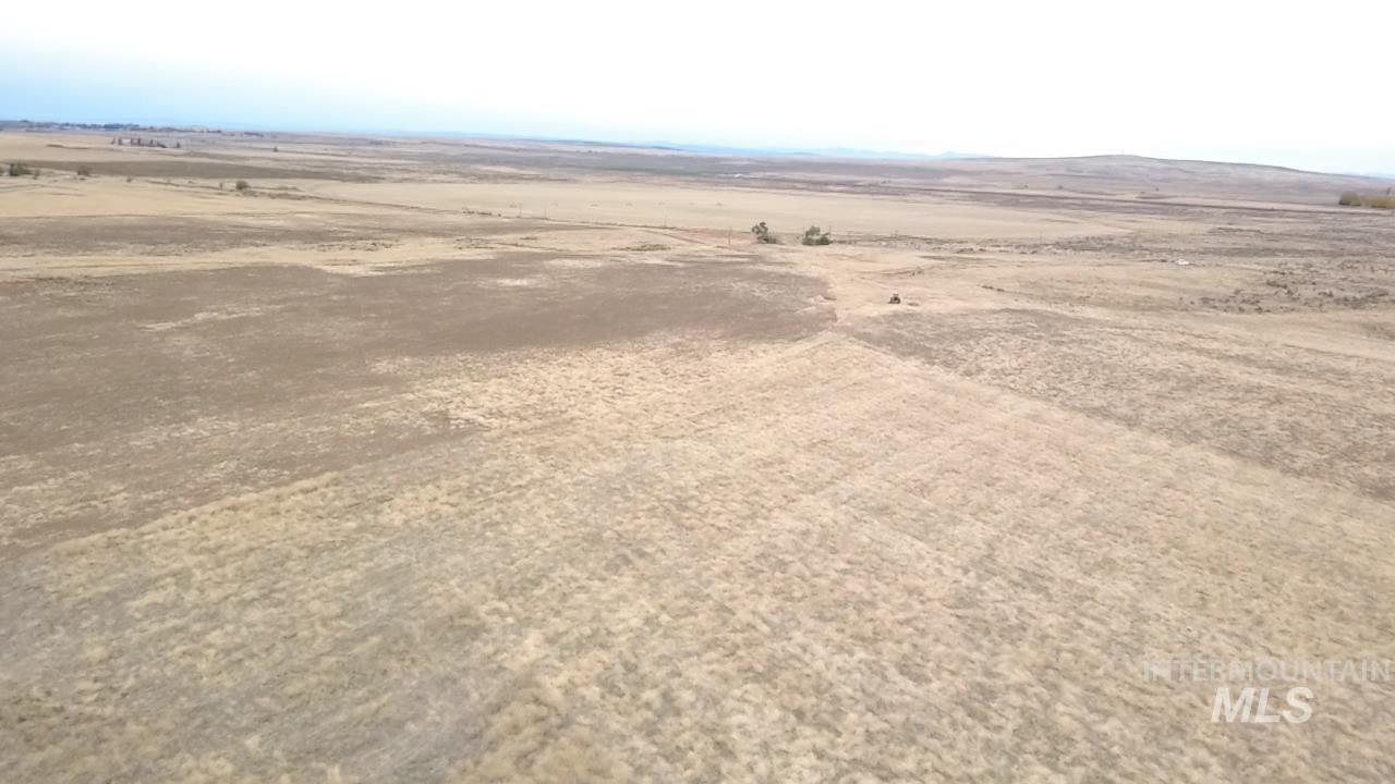 Aerial view of sparsely populated area with a desert landscape and a mountainous background