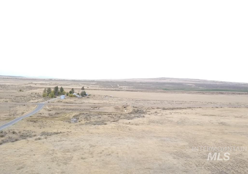 Aerial view of sparsely populated area featuring a desert landscape and a mountain backdrop