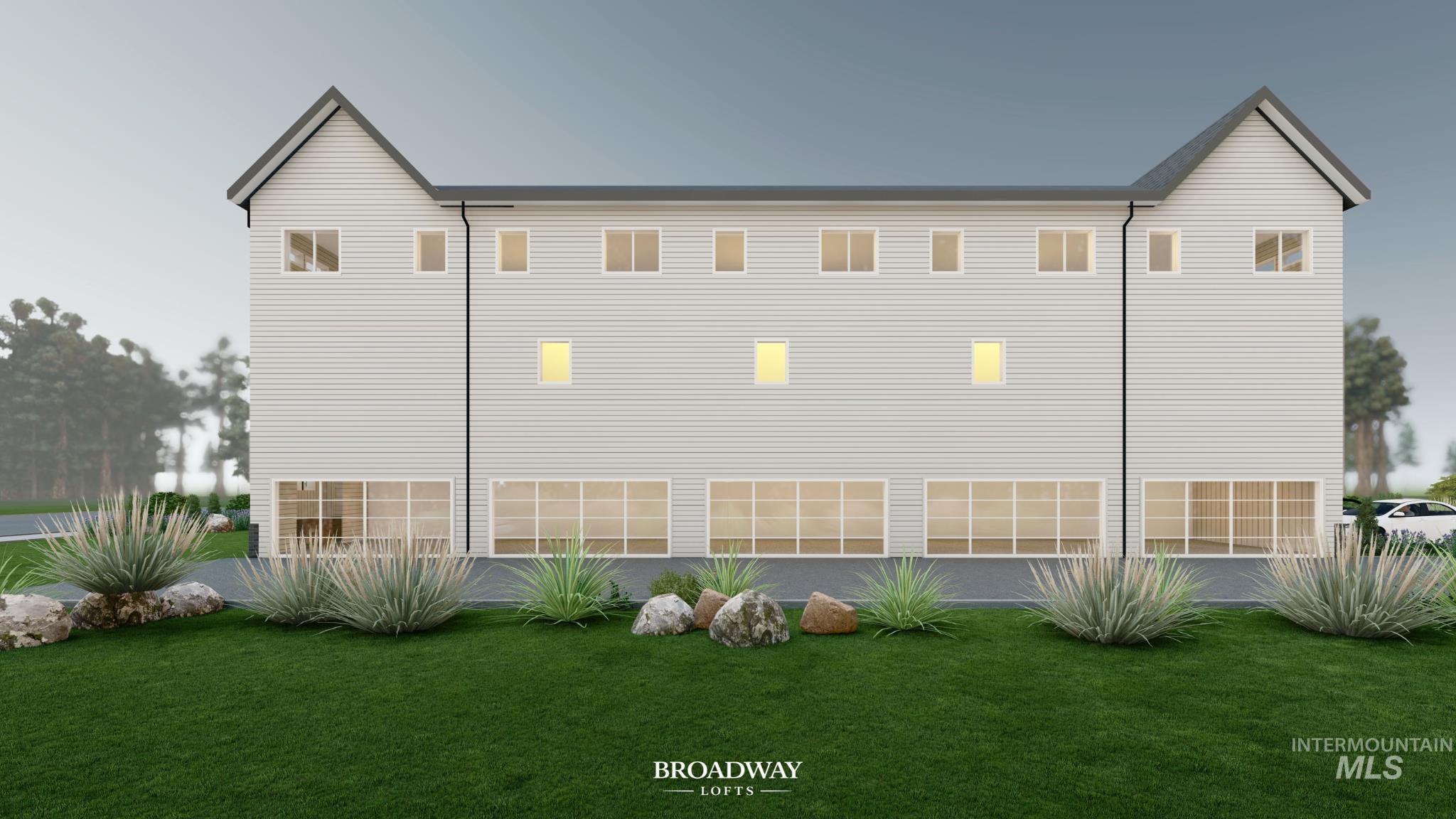 Back of property with a lawn