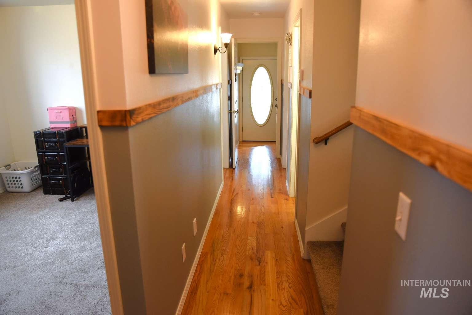 Hall with light wood finished floors and baseboards