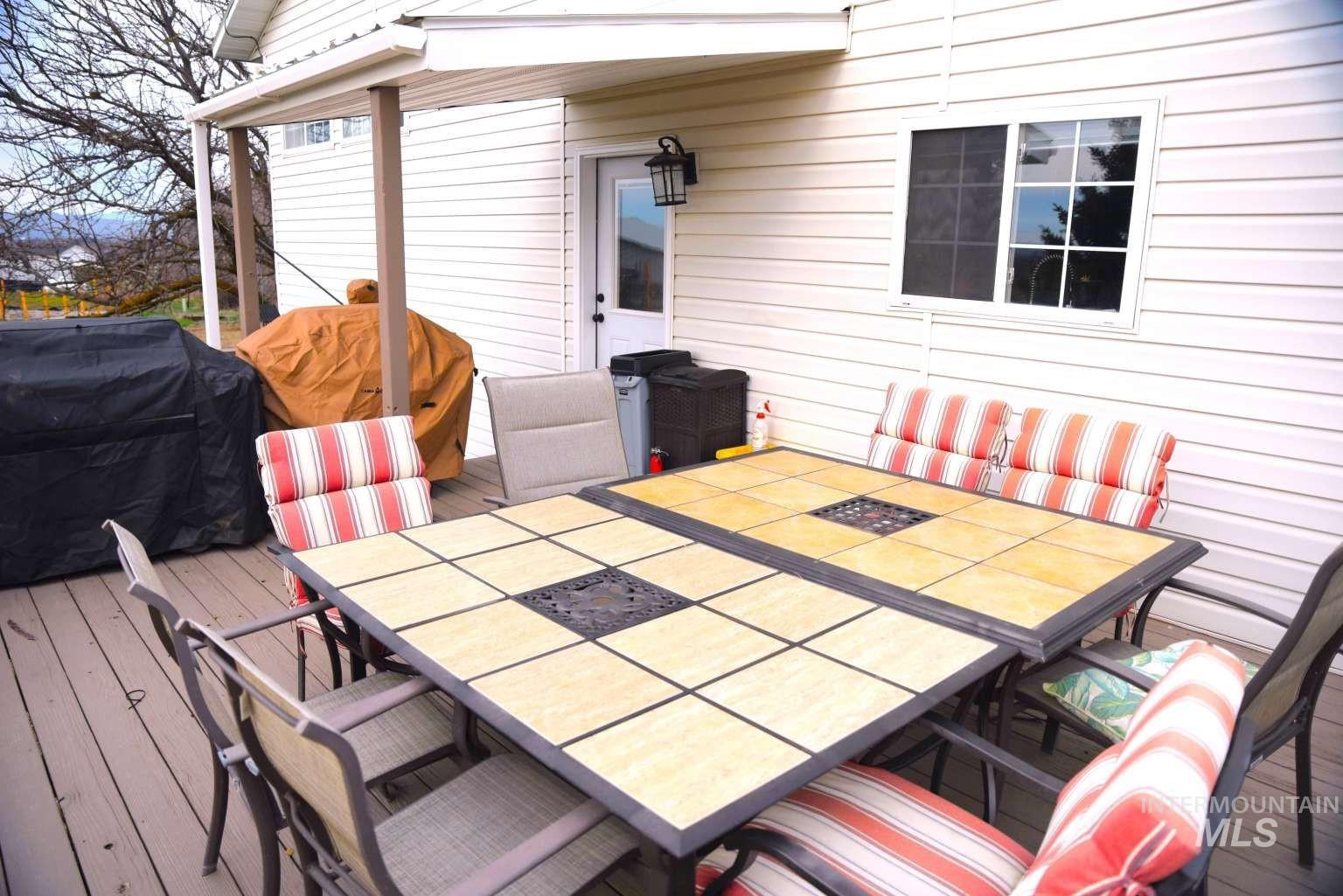 Deck with outdoor dining space and area for grilling