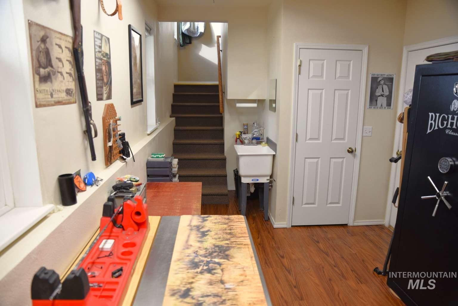 Corridor featuring dark wood-type flooring and stairs