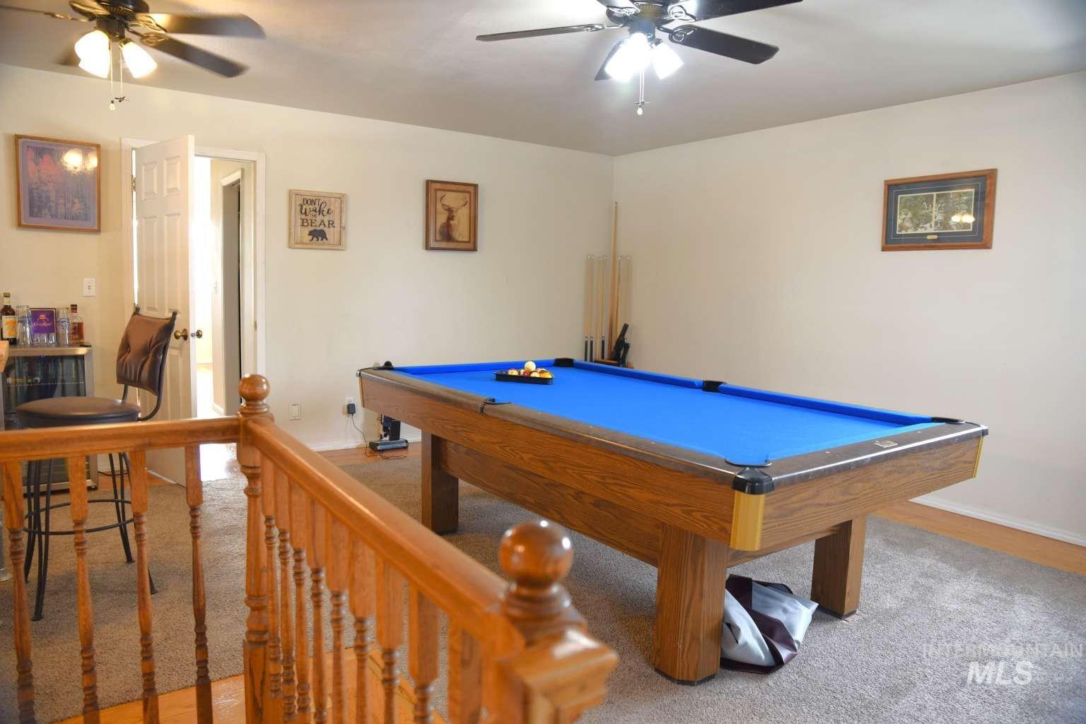 Rec room featuring ceiling fan, billiards table, and light carpet