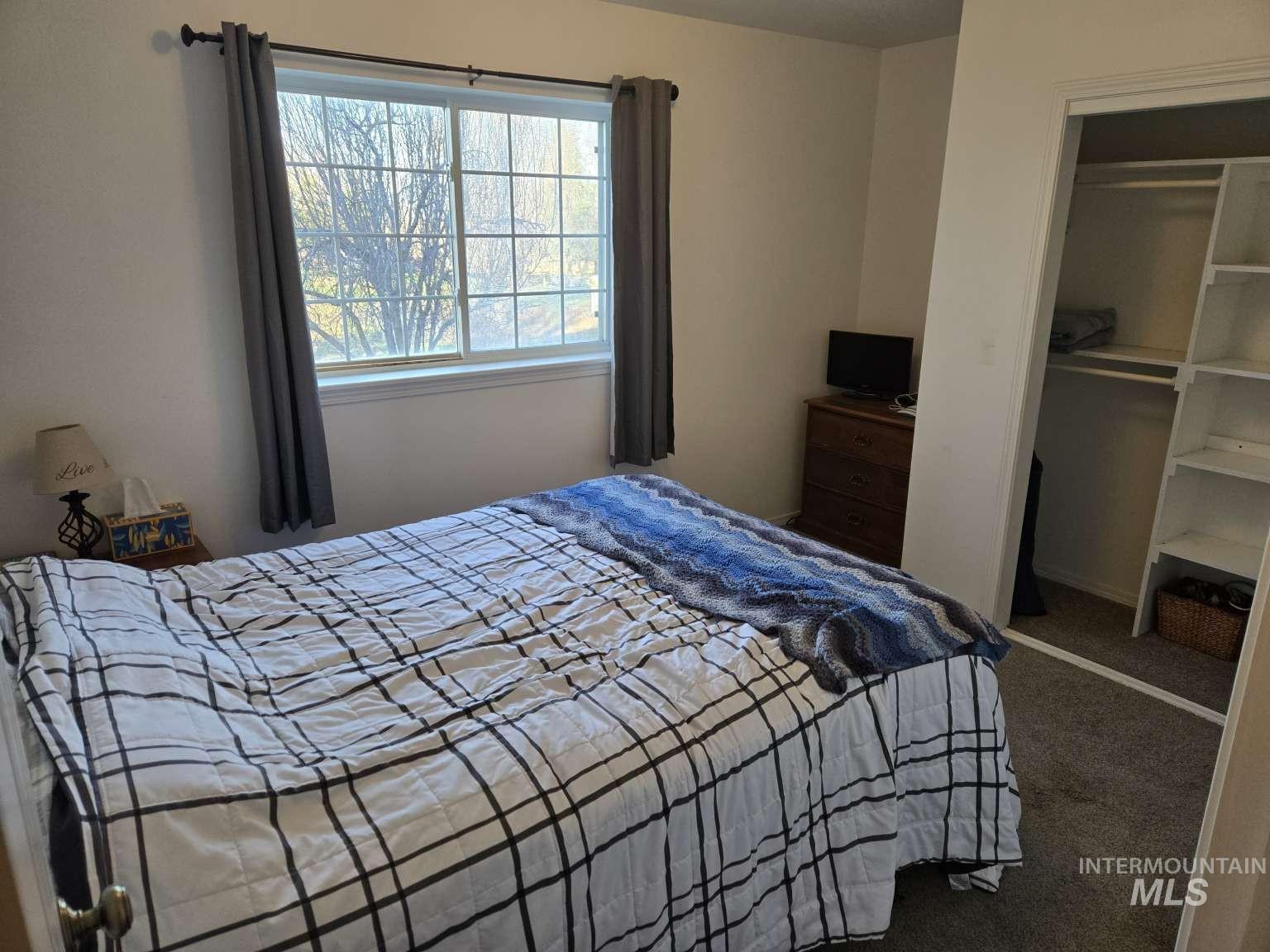 Bedroom with carpet floors and a closet
