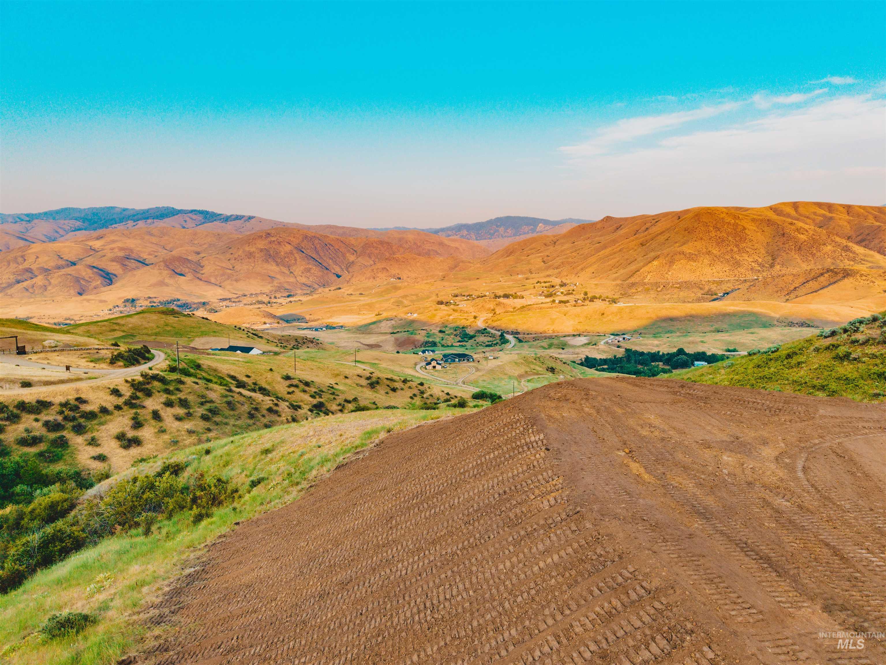 View of mountain backdrop with rural landscape
