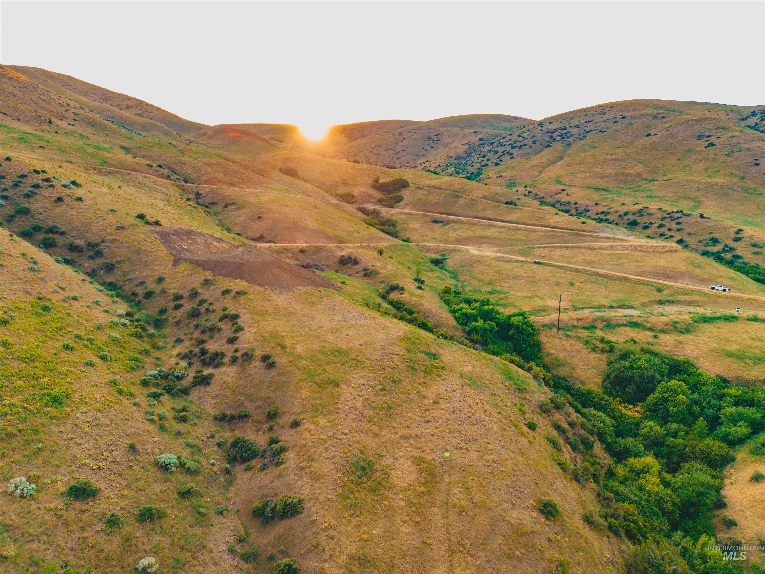 View of mountain backdrop with rural landscape