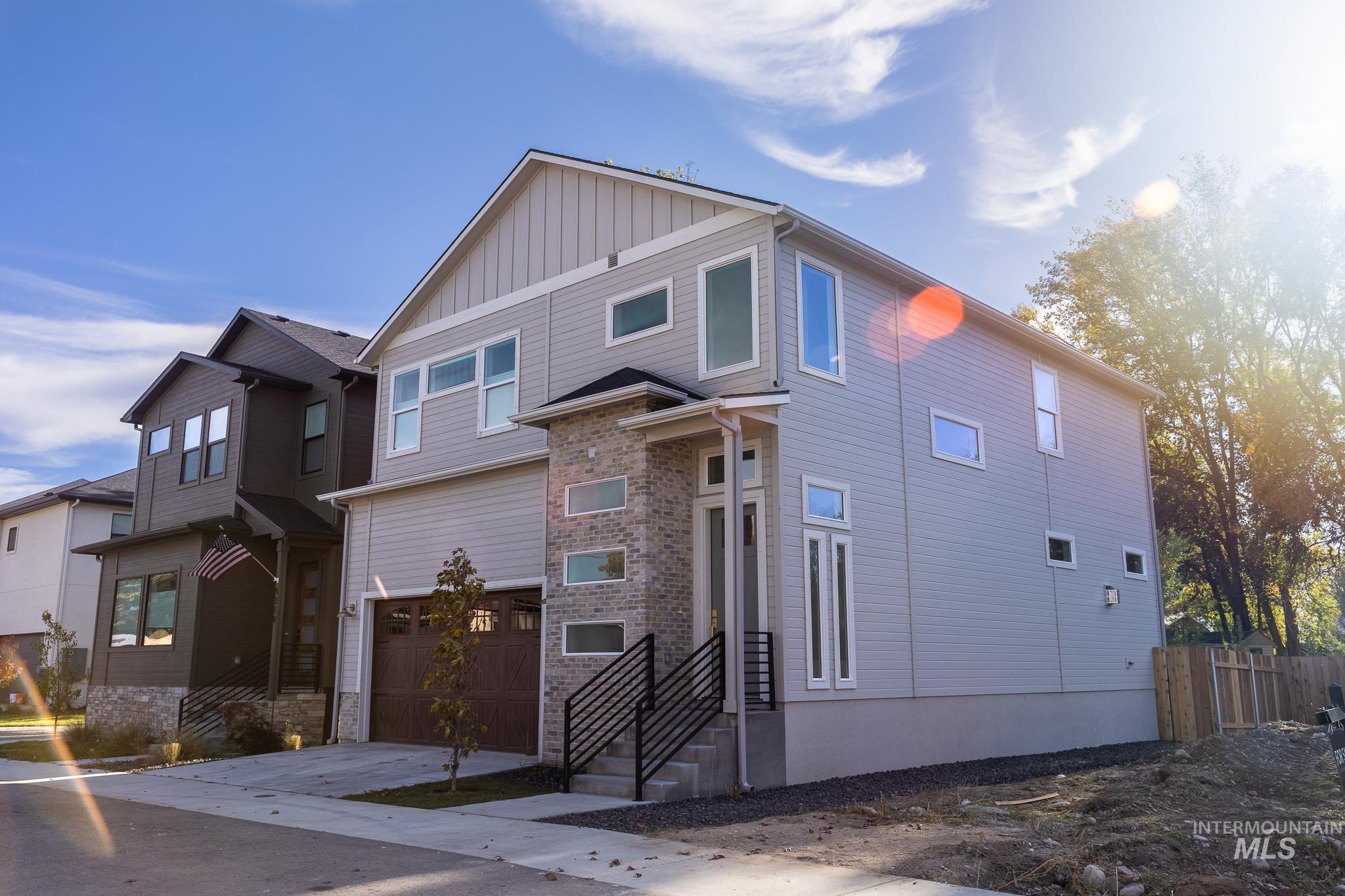 View of front of house featuring a garage, driveway, and board and batten siding