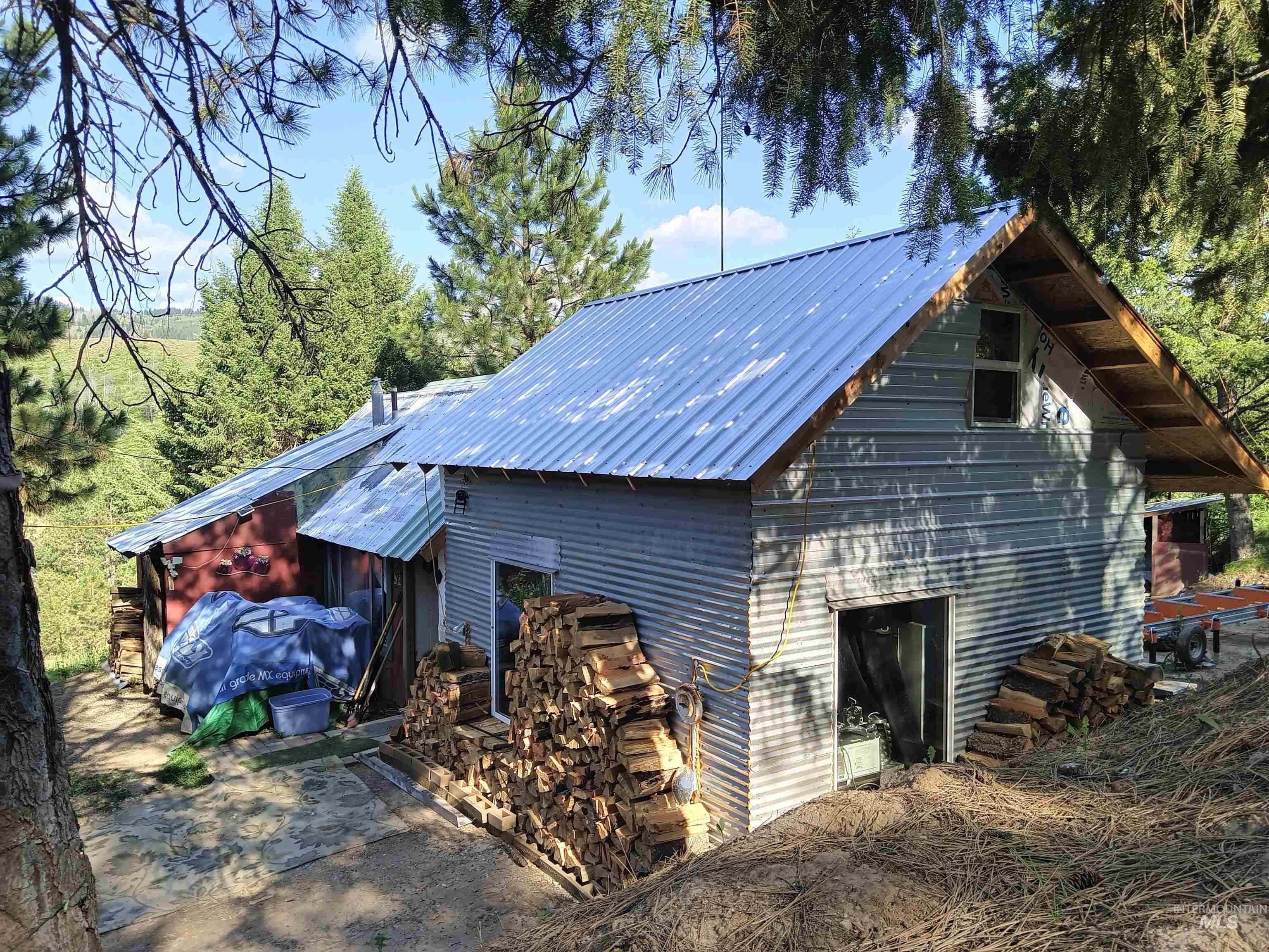 Metal-sided structure with a corrugated metal roof and exposed wood eaves